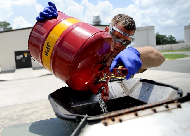 Staff Sgt. Mark Heitkamp dumps fuel samples into the reclaimable waste bowser behind the fuel pump house July 20, 2010 on Joint Base Charleston, S.C. Once the bowser is full, hydrants take the bowser to storage and pump it into the product recovery tank and the fuel is then pumped back into the fuel system for use. Sergeant Heitkamp is the noncommisioned office in charge of the fuels laboratory with the 628th Logistics Readiness Squadron. (U.S. Air Force photo/Senior Airman Timothy Taylor)
