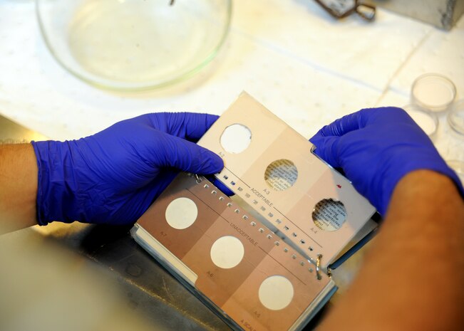 Staff Sgt. Mark Heitkamp uses the Aviation Turbine Fuel Contamination Standards book to verify the color of the fuel sample July 20, 2010 on Joint Base Charleston, S.C. The maximum allowed by the ATFCSB is A-4. Samples are drawn to ensure uncontaminated, clean, dry fuel is issued to the aircraft. Sergeant Heitkamp is the noncommisioned office in charge of the fuels laboratory with the 628th Logistics Readiness Squadron. (U.S. Air Force photo/Senior Airman Timothy Taylor)