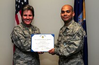 Senior Airman Jonathon Lovelady is presented the Joint Accommodation Medal by Col. Martha Meeker July 16, 2010, on Joint Base Charleston, S.C. Colonel Meeker is the commander of Joint Base Charleston. Airman Lovelady is a photographer with the 1st Combat Camera Squadron. (U.S. Air Force photo/Senior Airman Tyler Placie)