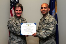Senior Airman Jonathon Lovelady is presented the Joint Accommodation Medal by Col. Martha Meeker July 16, 2010, on Joint Base Charleston, S.C. Colonel Meeker is the commander of Joint Base Charleston. Airman Lovelady is a photographer with the 1st Combat Camera Squadron. (U.S. Air Force photo/Senior Airman Tyler Placie)