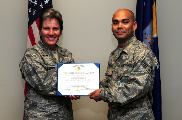 Senior Airman Jonathon Lovelady is presented the Joint Accommodation Medal by Col. Martha Meeker July 16, 2010, on Joint Base Charleston, S.C. Colonel Meeker is the commander of Joint Base Charleston. Airman Lovelady is a photographer with the 1st Combat Camera Squadron. (U.S. Air Force photo/Senior Airman Tyler Placie)