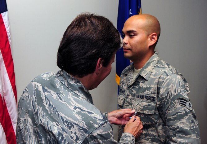 Senior Airman Jonathon Lovelady is presented the Joint Accommodation Medal by Col. Martha Meeker July 16, 2010, on Joint Base Charleston, S.C. Colonel Meeker is the commander of Joint Base Charleston. Airman Lovelady is a photographer with the 1st Combat Camera Squadron. (U.S. Air Force photo/Senior Airman Tyler Placie)