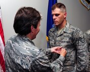 Staff Sgt. David Bertles is presented the Joint Accommodation Medal by Col. Martha Meeker July 16, 2010, on Joint Base Charleston, S.C. Colonel Meeker is the commander of Joint Base Charleston. Sergeant Bertles is a videographer with the 1st Combat Camera Squadron. (U.S. Air Force photo/Senior Airman Tyler Placie)