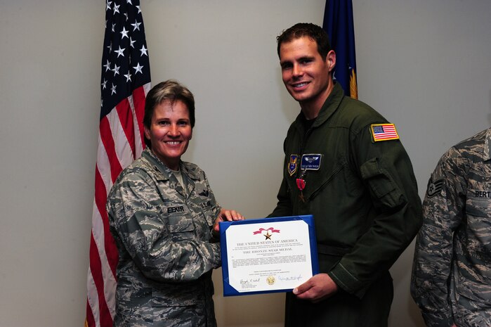 Staff Sgt. Matt Pardini is presented the Bronze Star Medal by Col. Martha Meeker for his exceptionally meritorious achievement in support of Operation Iraqi Freedom July 16, 2010, on Joint Base Charleston, S.C. Colonel Meeker is the commander of Joint Base Charleston. Sergeant Pardini is a videographer with the 1st Combat Camera Squadron. (U.S. Air Force photo/Senior Airman Tyler Placie)