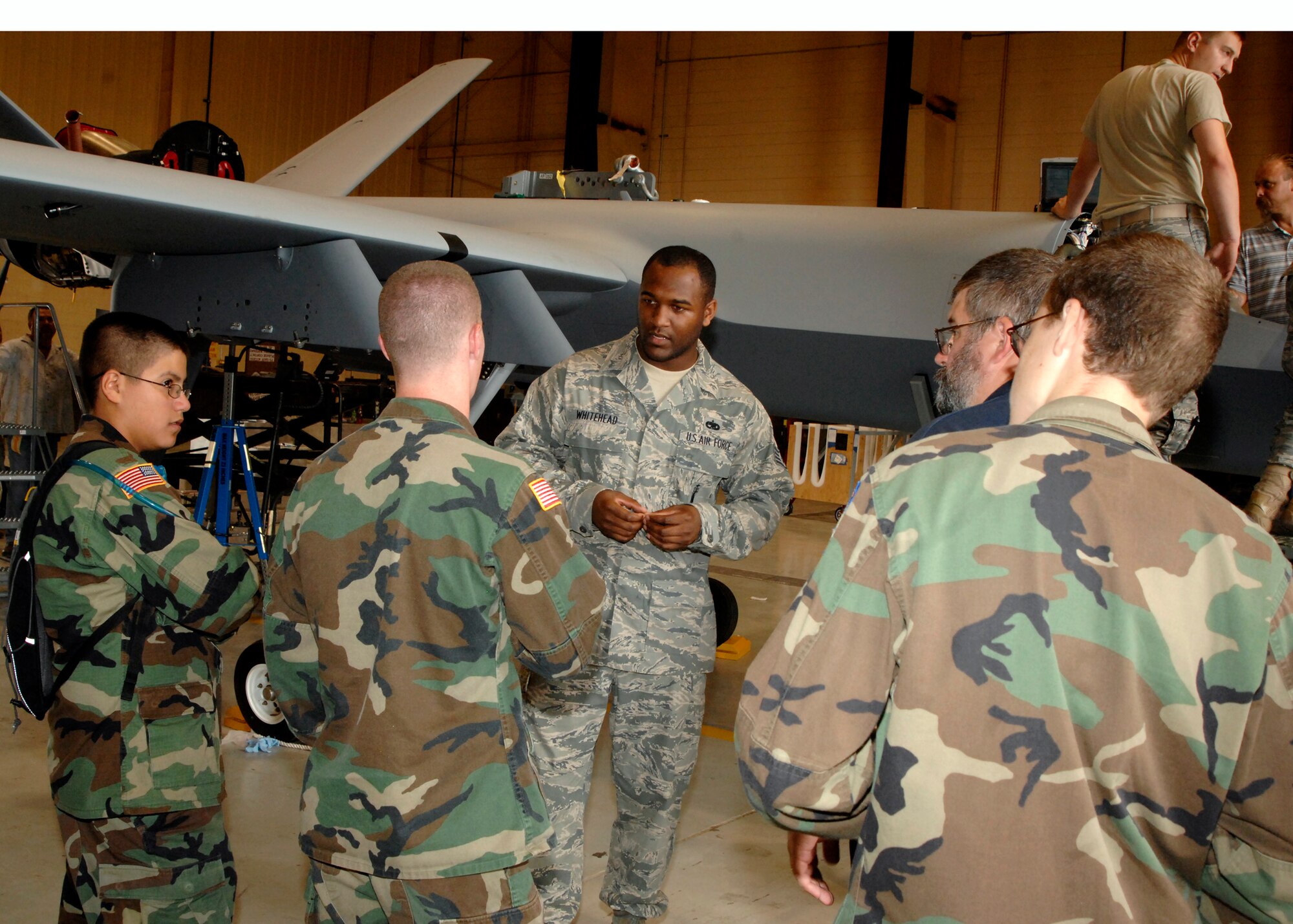 Staff Sgt. George Whitehead, 27th Special Aircraft Maintenance Squadron, answers questions about the MQ-9 Reaper from Civil Air Patrol cadets during their visit to Cannon Air Force Base, N.M. July 9, 2010. Cadets from Amarillo and Lubbock, Texas as well as Clovis, N.M., toured the base and got the opportunity to fly in a 16th Special Operations Squadron aircraft. (U.S. Air Force photo by Greg Allen) (RELEASED)