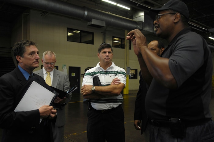 Mr. Bobby Robinson guides a group of scientists and engineers from the Air Force Research Laboratory  through the 437th Aerial Port Squadron July 16, 2010. The researchers mission is to use advanced technologies to improve deployed air base capabilities. Many of the developing ideas are new aged and unique, but surprisingly not far from being implemented. Mr. Robinson is an air freight supervisor with the 437 APS. (U.S. Air Force Photo/Airman 1st Class Lauren Main)