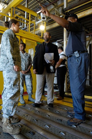 Senior Airman Jessica Stanley,left, and Bobby Robinson, right, give a tour of the 437th Aerial Port Squadron to scientists and engineers from the Air Force Research Laboratory July 16, 2010.  The researchers came from Tyndall  Air Force Base to tour the facility and see what changes could be made to improve efficiency and decrease work loads. Airman Stanley is a cargo journeyman and Mr. Robinson is an air freight supervisor, both with the 437 APS. (U.S. Air Force Photo/Airman 1st Class Lauren Main)