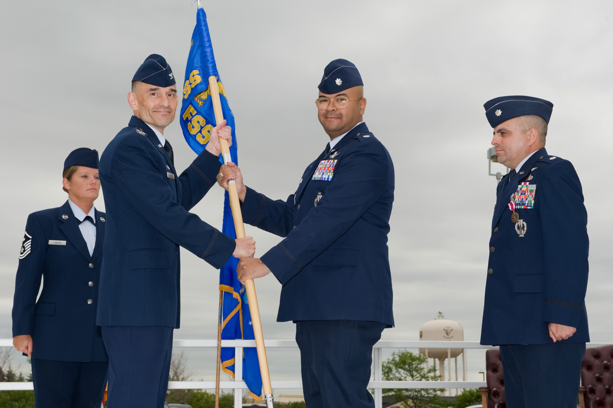 Lt. Col. William Wade accepts command of the 341st Force Support Squadron from Col. John Patricola, 341st Mission Support Group commander, July 21 at Medal of Honor Park. Lt. Col. Charles Ashmore, outgoing 341st FSS commander, and Master Sgt.  Sheila Lawson, 341st FSS  First Sergeant look on. (U.S. Air Force photo/Beau Wade)