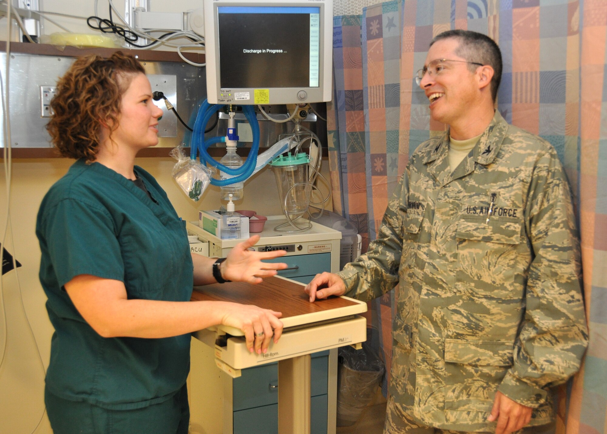 First Lt. Mary Dobrinski chats with Col. (Dr.) Joseph Giovannini, new 81st Surgical Operations Squadron commander, as he visits the post anesthesia care unit July 15. Colonel Giovannini assumed command of the squadron from Col. (Dr.) Bartlett Hayes June 17.  The new commander comes to comes to Keesler from Travis Air Force Base, Calif., where he commanded the 60th Surgical Operations Squadron surgical specialties flight.  Colonel Hayes, squadron commander since 2007, is headed to Houston for an Air Force Institute of Technology-approved two-year fellowship in retina and uveitis surgery.  (U.S. Air Force photo by Steve Pivnick)