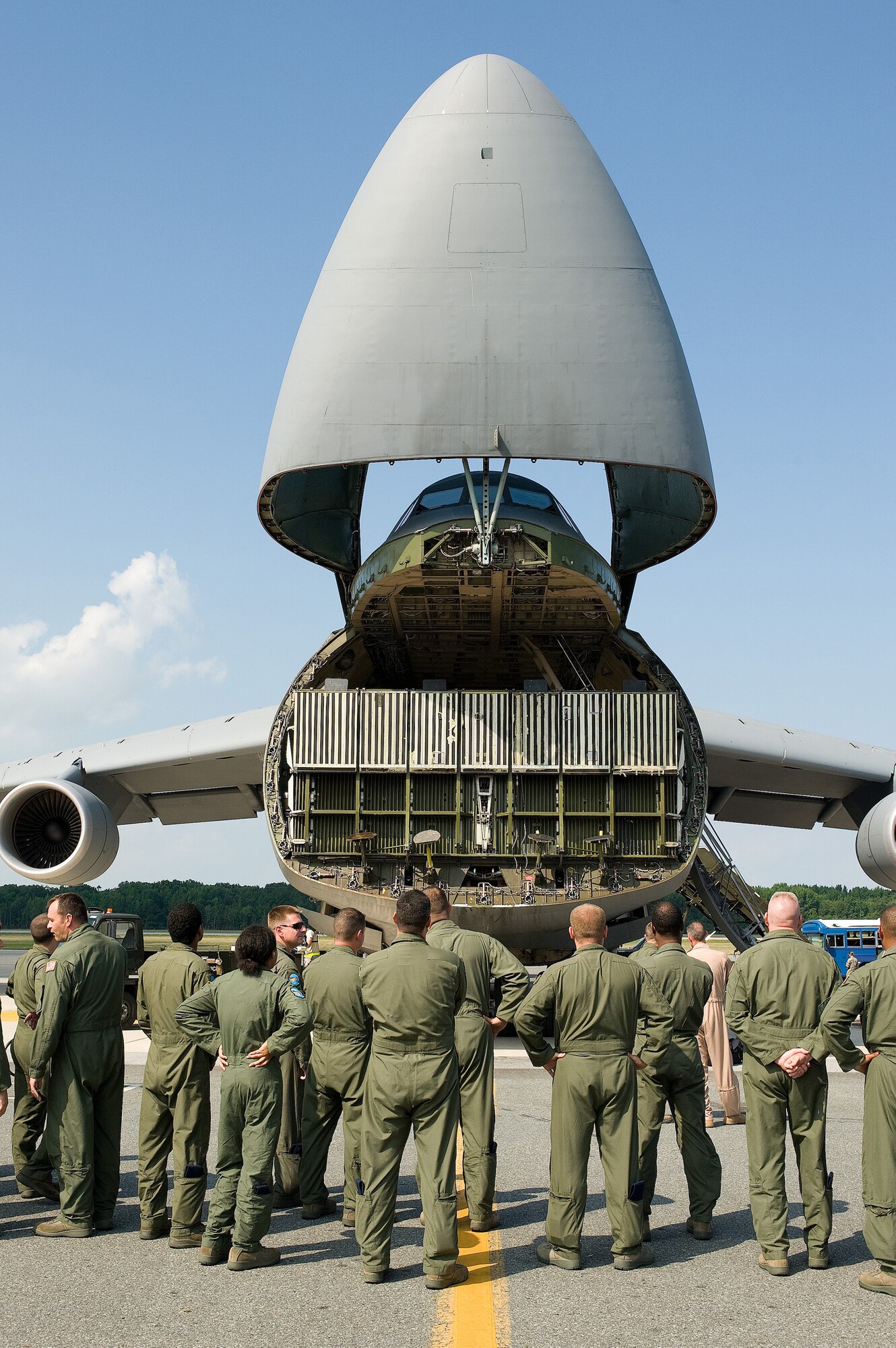 Members of the 9th Airlift Squadron wait on the flight line to welcome home the returning crew members on Dover Air Force Base, Del., July 15, 2010.  Dover aircrews delivered over 100 helicopters to Army units in Afghanistan.  (U.S. Air Force photo by Jason Minto/released)