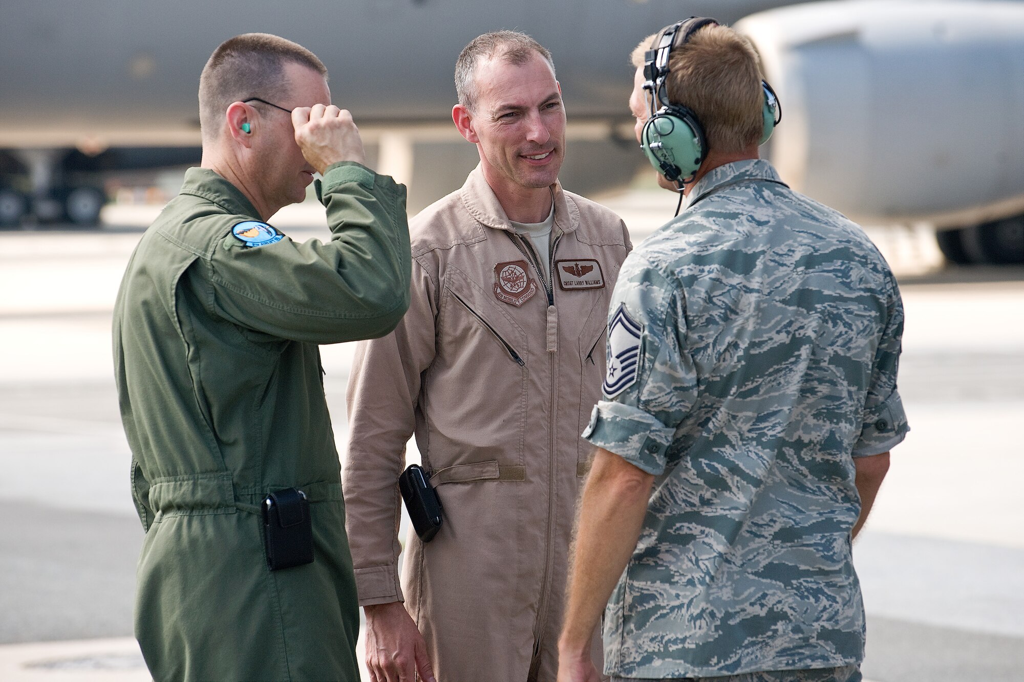 Chief Master Sgt. Larry Williams, 436th Operations Group superintendent, speaks with members of the 9th Airlift Squadron on the flightline at Dover Air Force Base, Del., July 15, 2010.  Chief Williams was welcomed back after taking part in a 30-day mission to deliver Army helicopters to units in Afghanistan.  (U.S. Air Force photo by Roland Balik/released)