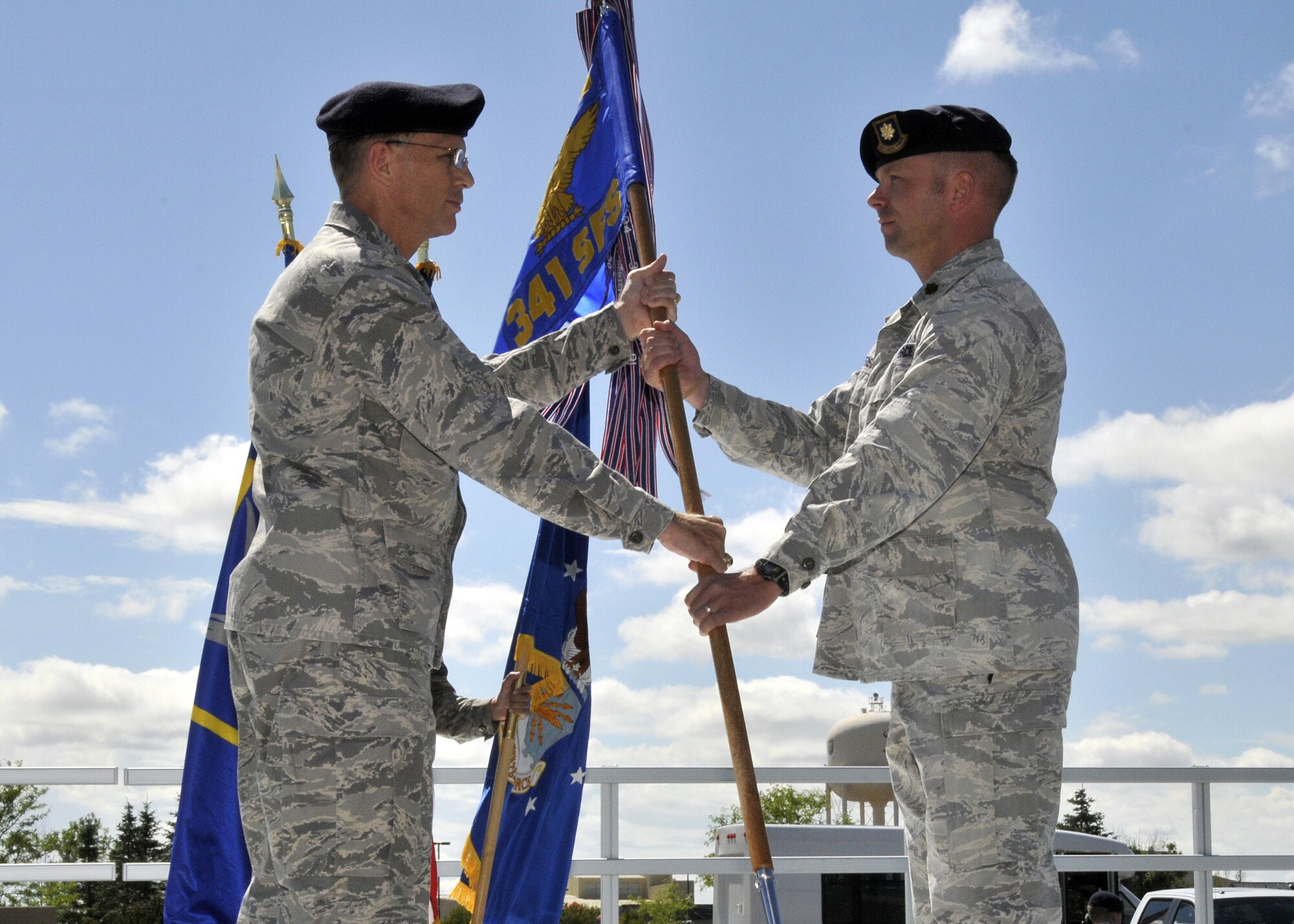 Maj. Walter Sorensen accepts command of the 341st Security Forces Squadron from Col. Robert Mendenhall, 341st Security Forces Group commander, during an assumption of command ceremony July 19. (U.S. Air Force photo/John Turner)