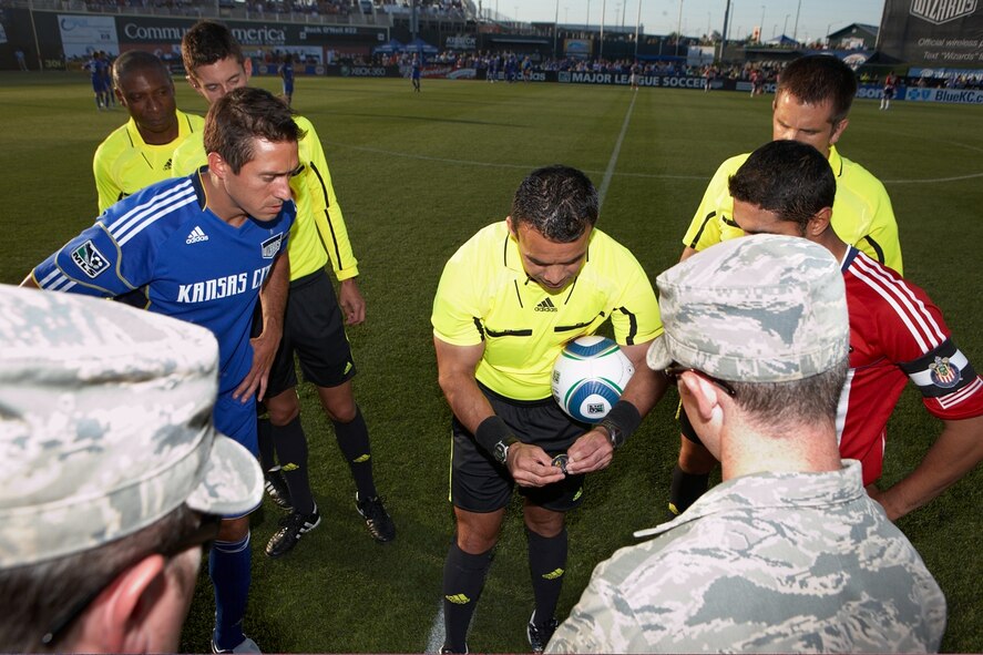 Members of the 509th Operations Support Squadron attended a Kansas City Wizards soccer match July 10. Airman 1st Class Kyle Ellis, the 509th OSS intramural soccer coach, presented a 509th Bomb Wing coin to the head referee for the official coin toss to determine which team has possession of the ball at the start of the game. (Courtesy photo) 