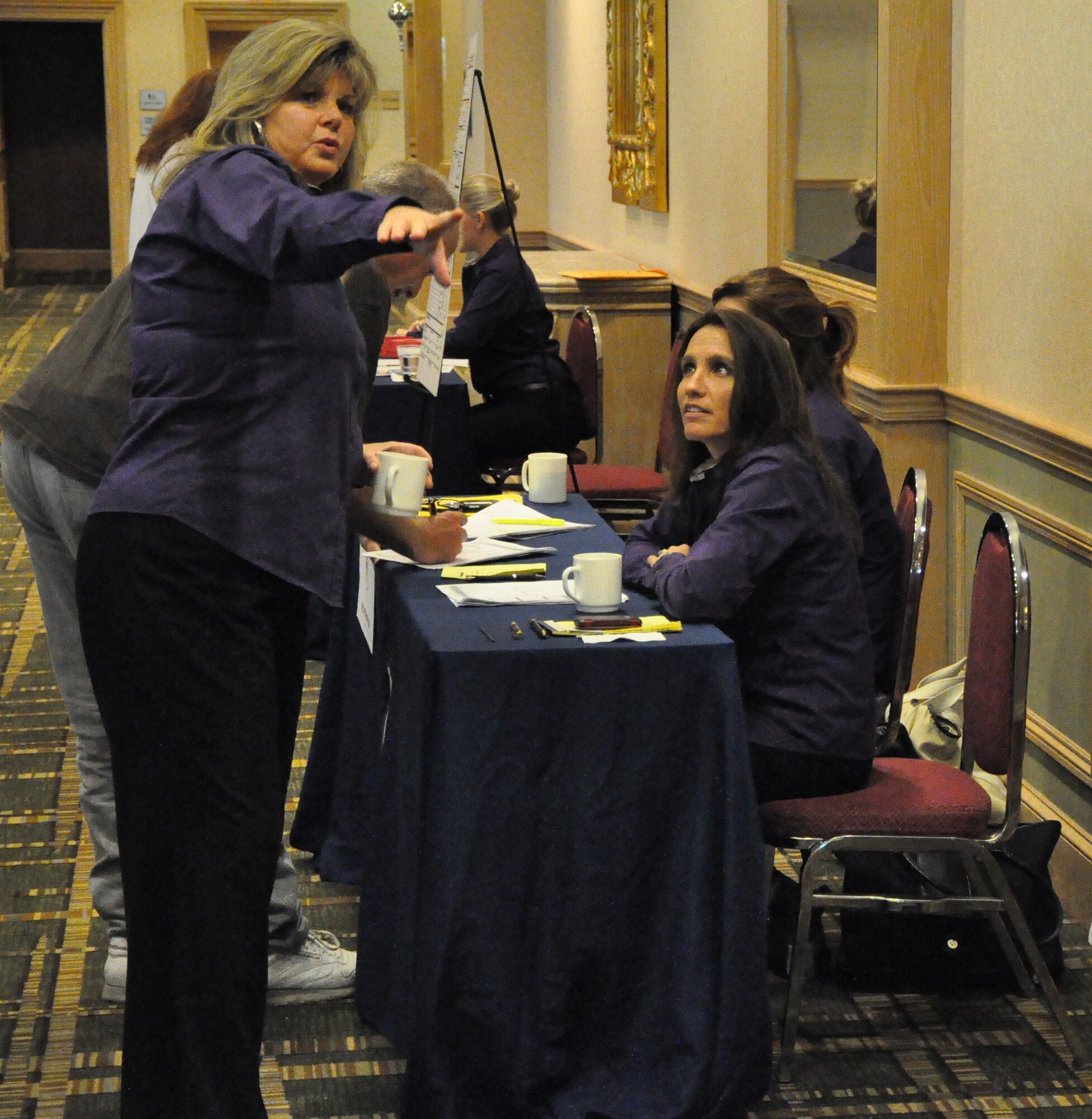 Debbie Johnson, GAP Solutions, Inc. yellow ribbon support specialist, talks to team members about registration during the Yellow Ribbon Reintegration Program event July 17-18 in Jacksonville, Fla. (U.S. Air Force photo/Staff Sgt. Shane Ellis)