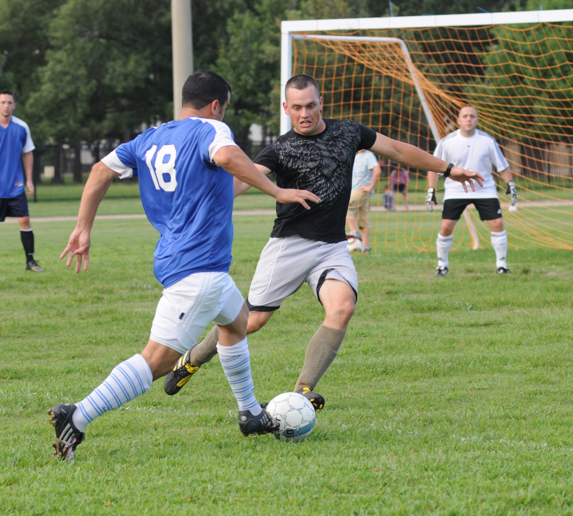 From left, Steven Haro, 334th Training Squadron, and Douglas Purinton, 335th TRS, battle for the ball Monday as 335th TRS goalie Justin Nacol prepares to defend.  (U.S. Air Force photo by Kemberly Groue)
