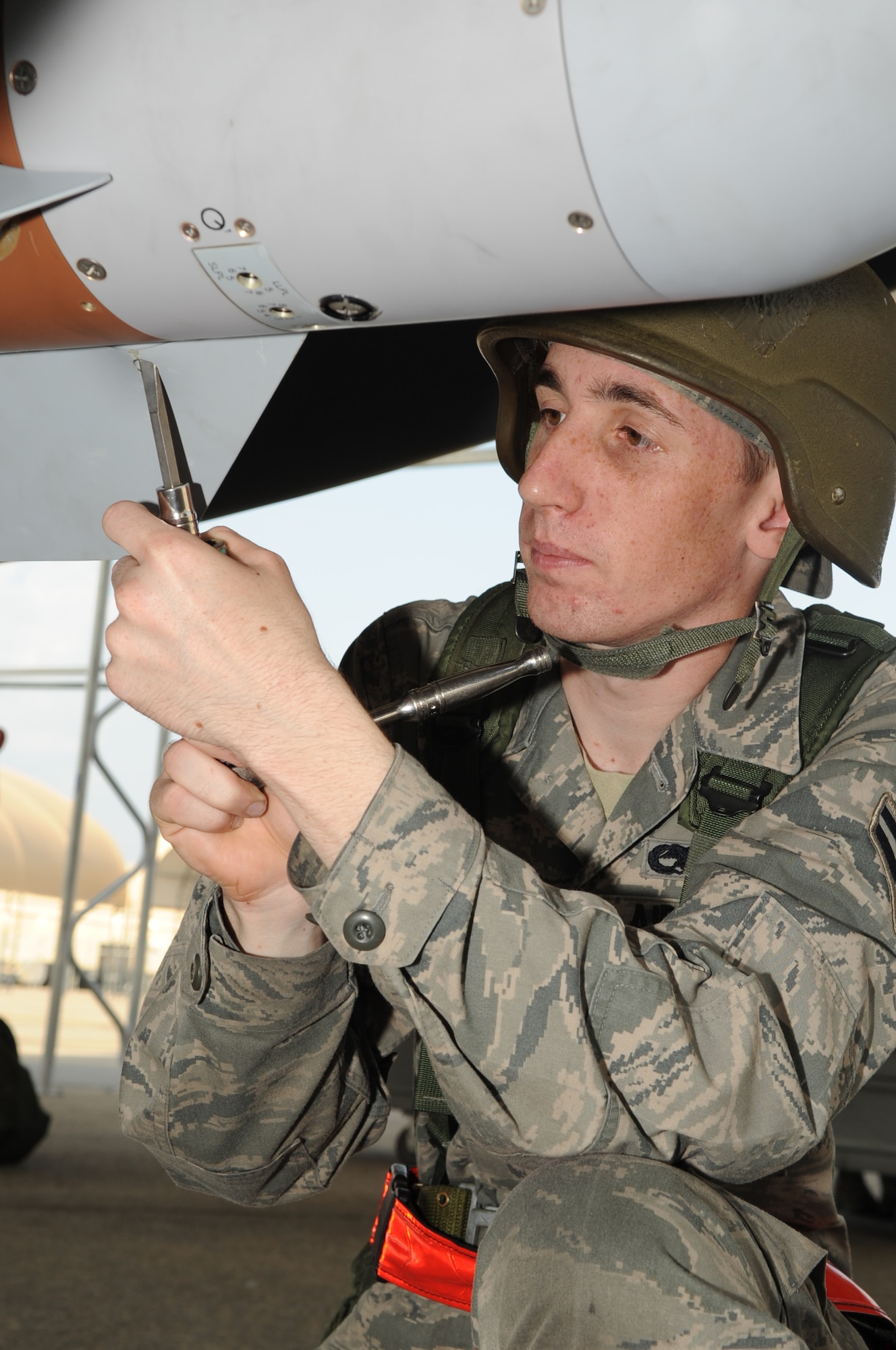 SEYMOUR JOHNSON AIR FORCE BASE, N.C. -- Airman 1st Class Kevin Carter torques a Guided Bomb Unit-12 fin during the regeneration phase of the operational readiness exercise Coronet Warrior 10-04, July 20, 2010. Airman Carter checks the fin to ensure it is secure during flight and will function properly when the unit is released. Airman Carter, 4th Aircraft Maintenance Squadron weapons load crew chief, is from Moreno Valley, Calif. (U.S. Air Force photo/Staff Sgt. Courtney Richardson) (RELEASED)