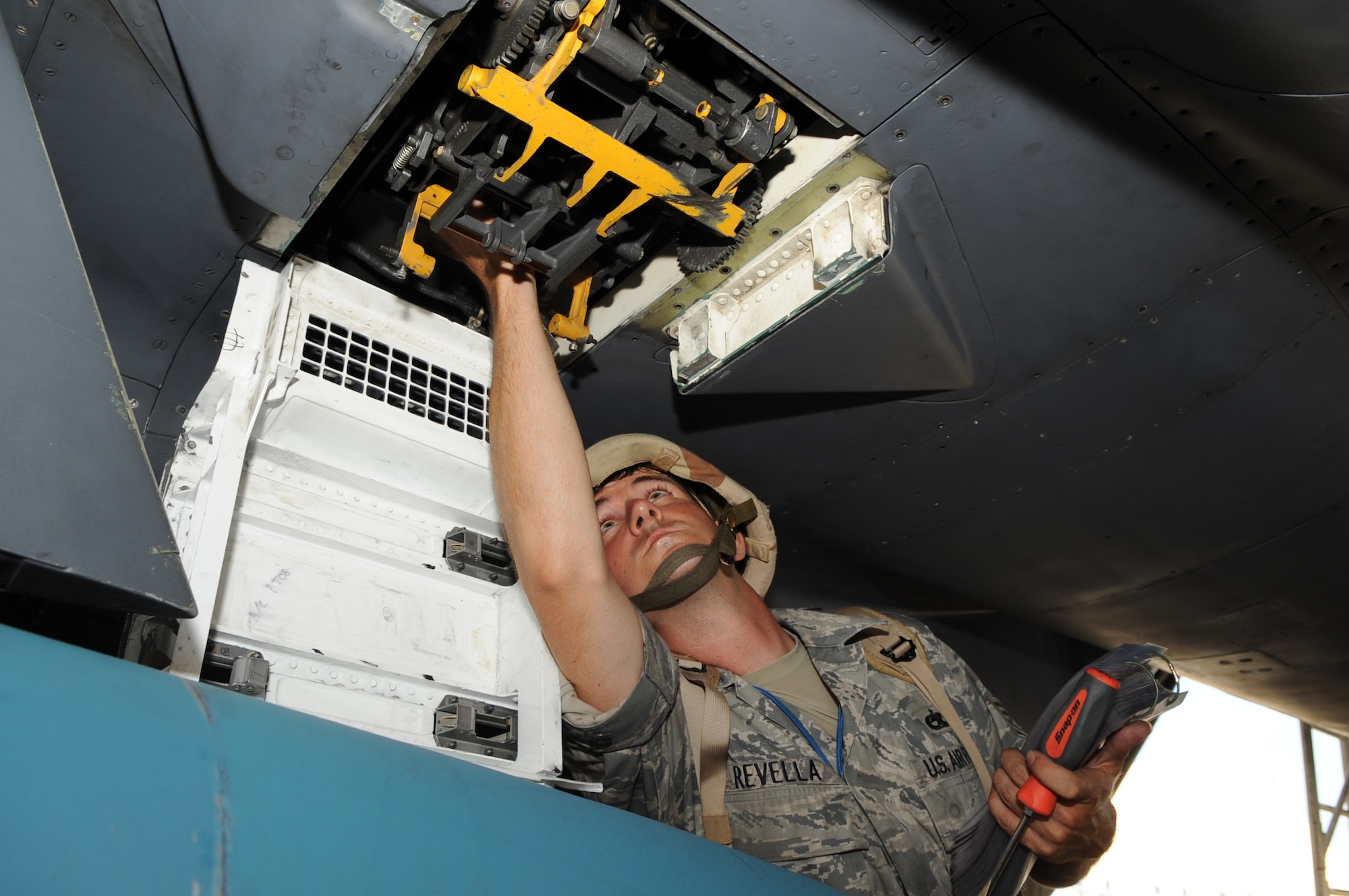 SEYMOUR JOHNSON AIR FORCE BASE, N.C. -- Staff Sgt. Derek Revella arms the 22-mm gun on a F-15E Strike Eagle during the operational readiness exercise Coronet Warrior 10-04 regeneration phase, July 20, 2010. To earn a satisfactory rating during the ORE regeneration phase 15 of 18 aircraft must be refueled, loaded with weapons, checked for general maintenance and serviceability, and sent on a specific combat sortie within 10 hours of landing in deployed location. Sergeant Revella, 4th Aircraft Maintenance Squadron weapons load crew chief, hails from Ellicott City, Md. (U.S. Air Force photo/Staff Sgt. Courtney Richardson) (RELEASED)