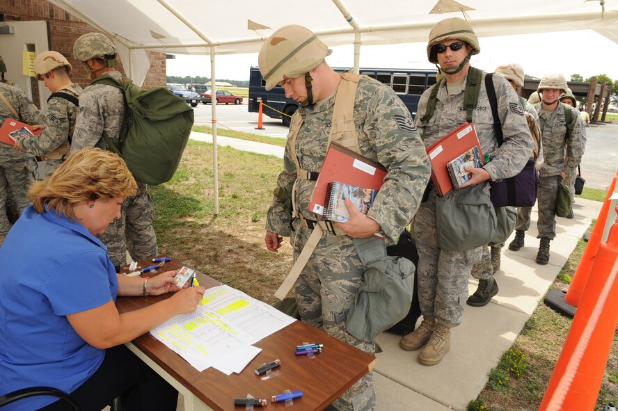 SEYMOUR JOHNSON AIR FORCE BASE, N.C. -- Joan Morton checks Airmen in at the personnel deployment facility during operational readiness exercise Coronet Warrior 10-04 here July 19, 2010. Deploying Airmen receive their final out-processing clearance at the PDF before boarding an aircraft. (U.S. Air Force photo/Senior Airman Gino Reyes)