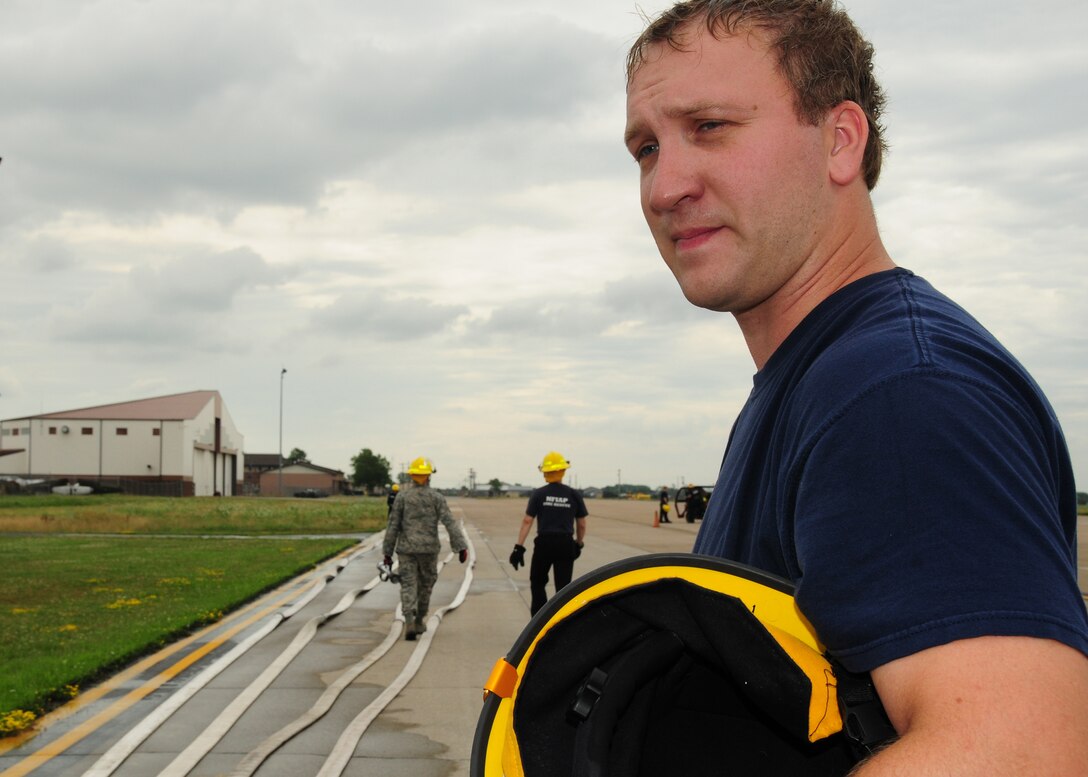 Civilian Lt.  Eric Krakowiak, 914th CES Fire Protection Flight, takes a break during an annual hose inspection July 20, 2010 Niagara Falls Air Reserve Station, Niagara Falls, NY. Fire hose inspections are performed to ensure the safety of the operators and  the hose, coupling assemblies, appliances and nozzles will perform as designed. (U.S. Air Force photo by Senior Airman Jessica Mae Snow) 