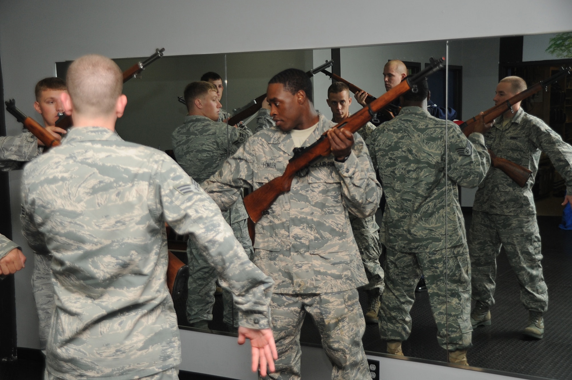 Staff Sgt. Victor Fowler, 305th Maintenance Squadron, teaches new honor guard members choreographed movements using a rifle during training at the Honor Guard facility here Tuesday. The Joint Base McGuire-Dix-Lakehurst Honor Guard is the busiest honor guard unit in the entire Air Force having performed more than 13,000 ceremonies since October 1. (U.S. Air Force photo/ Airman 1st Class Bryan Swink)