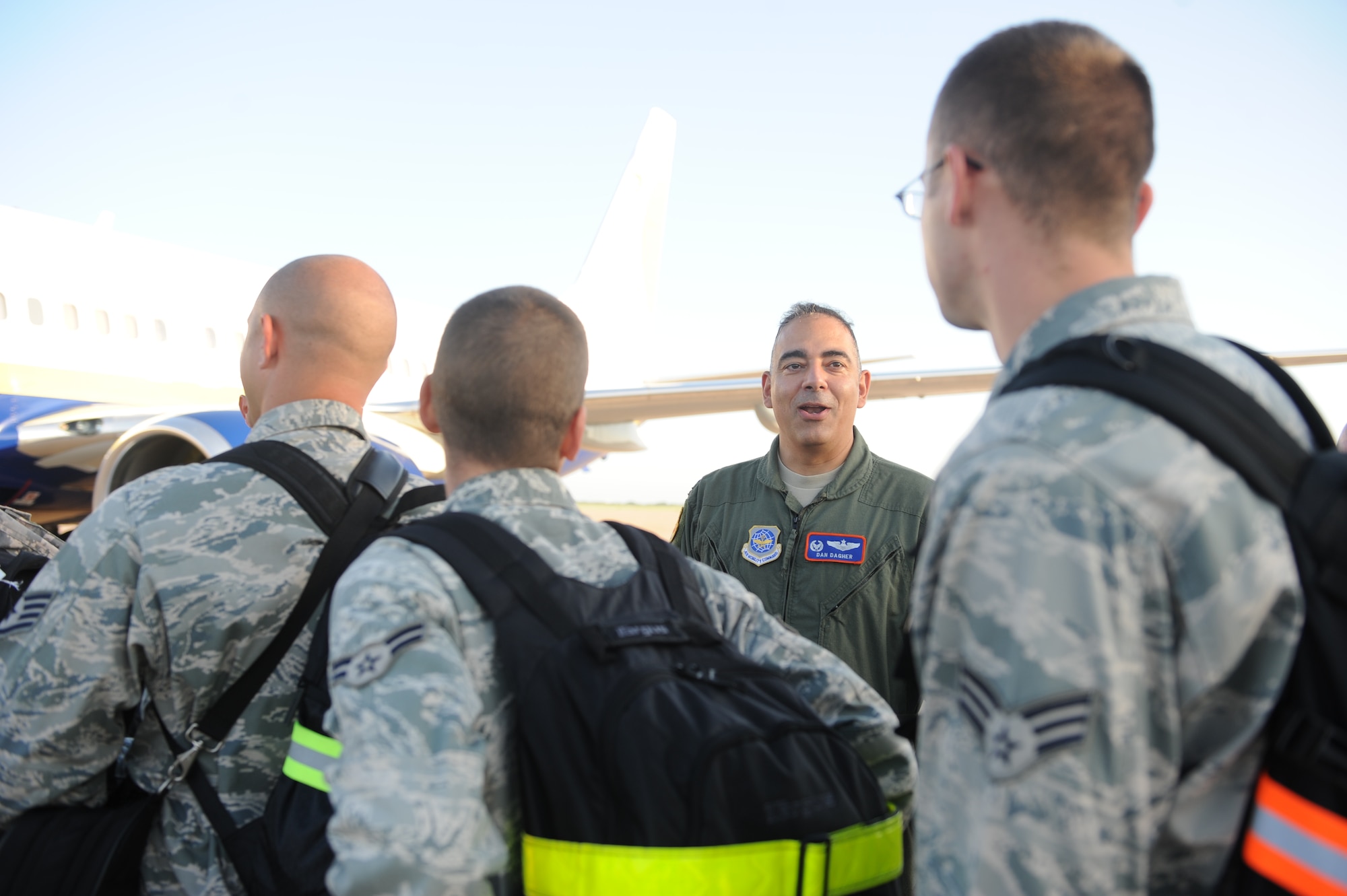 DYESS AIR FORCE BASE, Texas—Col. Dan Dagher, 317th Airlift Group Commander, shakes hands and bids farewell to Dyess Airman from the 9th Bomb Squadron and 7th Maintenance Group as they board a plane to Southwest Asia here, July 20.  The Airmen left on a six-month deployment in support of Operation Enduring Freedom.(U.S Air Force photo/ Airman 1st Class Shannon Hall)