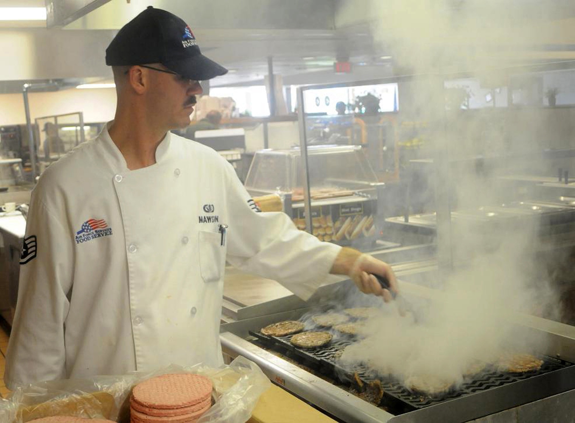 Staff Sgt. Thomas Mawson, 512th Memorial Affairs Squadron, Dover Air Force Base, Del., food preperation specialist, grills beef patties in Patterson Dining Facility kitchen here June 6. Sergeant Mawson is a traditional reservist who is a member of Delaware?s only Air Force Reserve Command unit. (U.S. Air Force photo/Senior Airman Bhawan P. Singh)