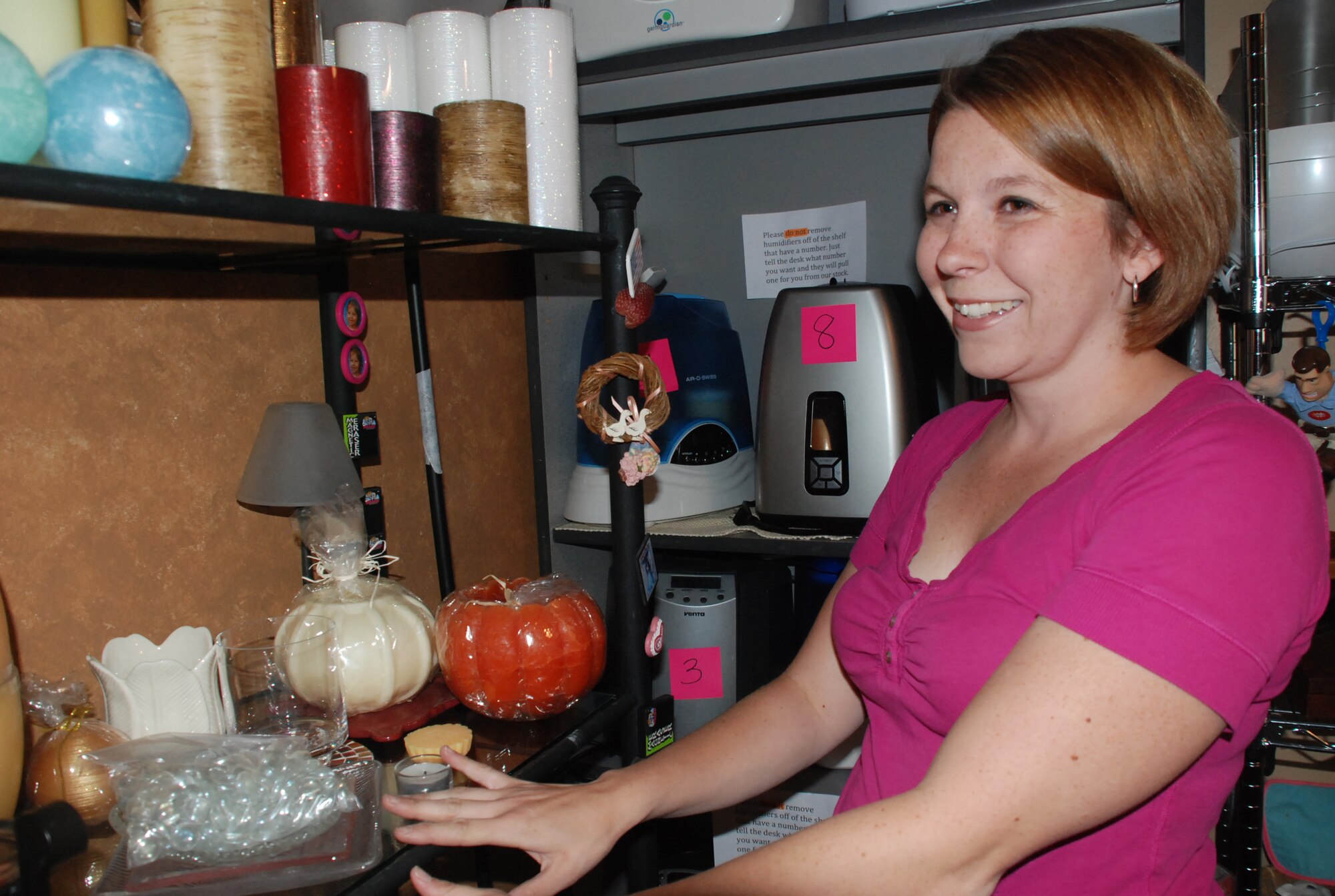 Cassie Nordin, pictured here in the home décor section of the Air Force Academy Airman's Attic, is the Attic's volunteer manager. The Attic, which recently relocated to a duplex in Douglass Valley Housing, is scheduled to hold a grand re-opening July 27, 2010. (U.S. Air Force photo/Ann Patton)