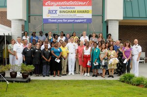 Naval Weapons Station Charleston's Navy Exchange management and employees join with distinguished guests following a ceremony awarding the Navy Exchange the Bingham Award July 15, 2010. Each year, the Bingham Award recognizes NEXs which have demonstrated excellence in customer service, operations and management. The NWS exchange placed first in the $20 to $40 million category with more than $24 million in sales for 2009. (U.S. Navy photo/Mass Communication Specialist 1st Class Jennifer Hudson/released)