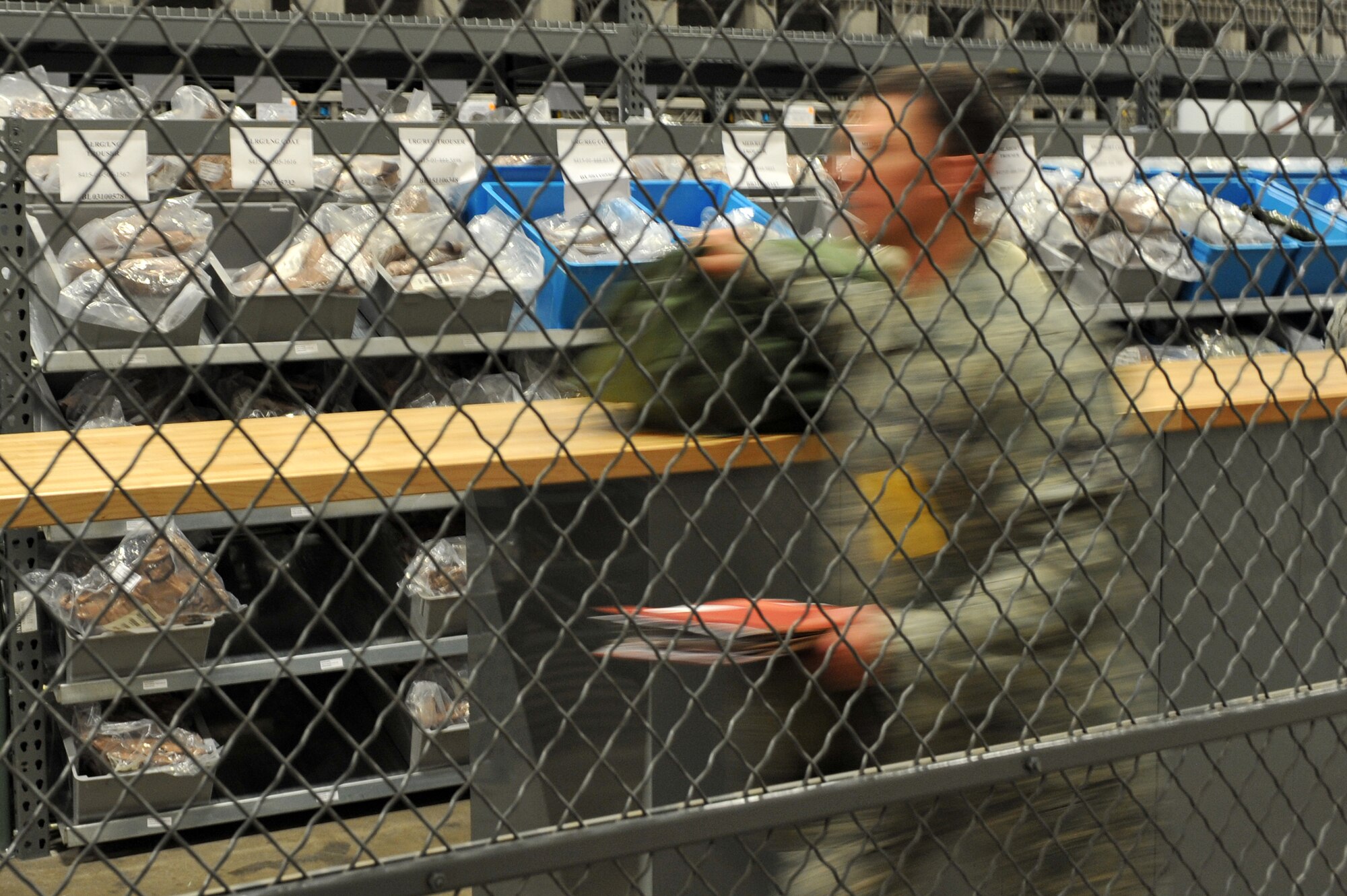 An Airman kits up for deployment at the passenger terminal July 18 as part of the RockEx. The 19th Airlift Wing Black Knights responded to a deployment exercise to hone their skills and stay mentally prepared for real-world operations. (U.S. Air Force photo by Senior Airman Steele C. G. Britton)