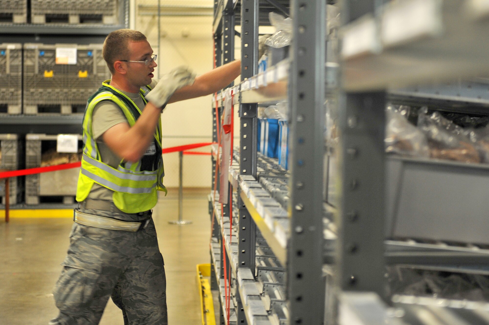 Airman 1st Class Clinton Anderson, a 19th Logistics Readiness Squadron fuels distribution operator, restocks mobility gear July 18 during an exercise at the passenger terminal. Several hundred Airmen deployed as part of an exercise while others sharpened their deployment readiness support. (U.S. Air Force photo by Senior Airman Steele C. G. Britton)