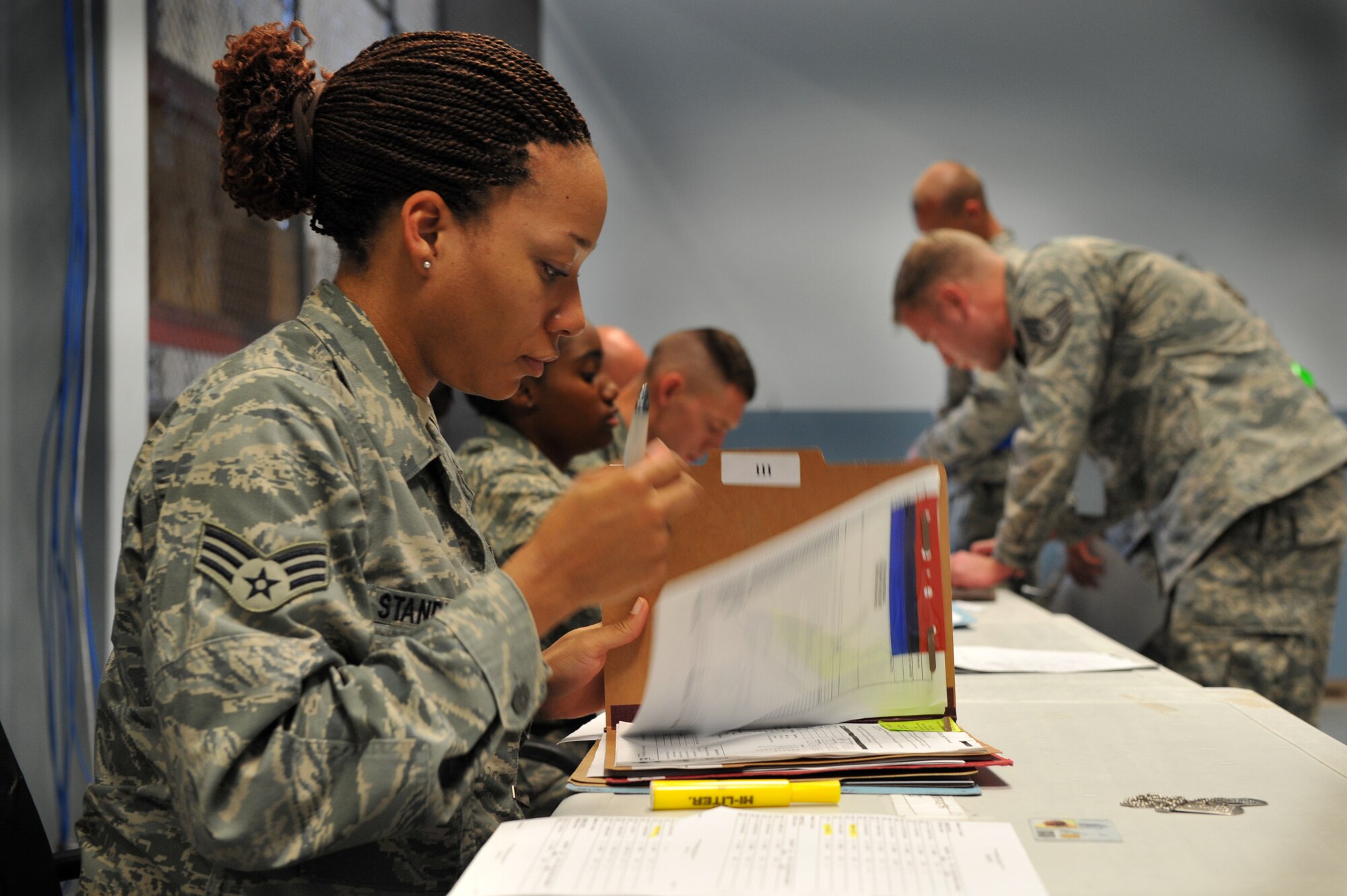 Senior Airman Doriannicole Standish, a 19th Force Support Squadron retirement and separations counselor, reviews mobility records July 18 for deployment eligibility at the passenger terminal on base. Airmen from the 19th Airlift Wing exercised deployment operations as part of a RockEx. (U.S. Air Force photo by Senior Airman Steele C. G. Britton)