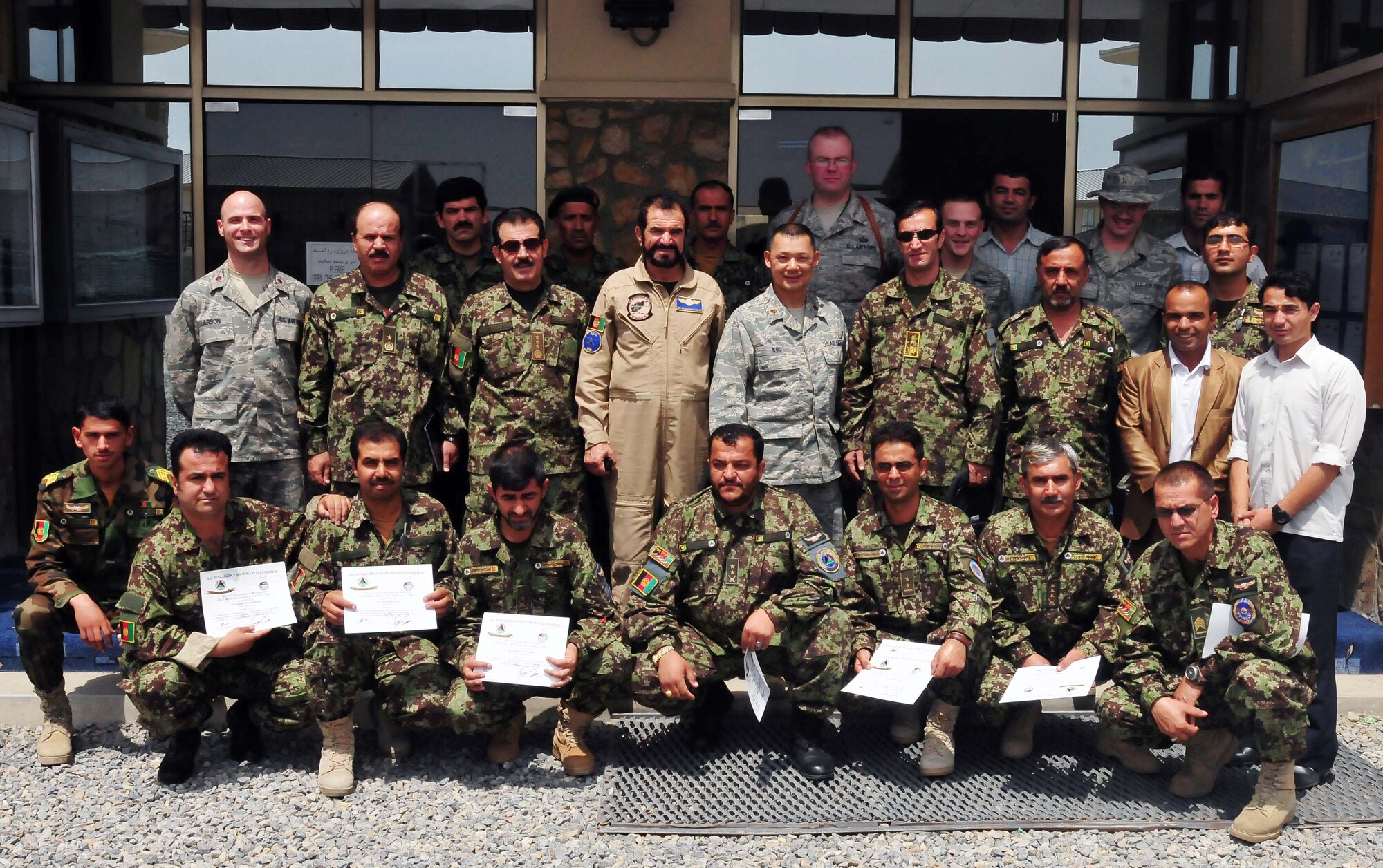 100721-N-6031Q-0025 KABUL, Afghanistan - Afghan Air Force Airmen graduate from the first Basic Intelligence Course designed and instructed by the Combine Air Power Transition Force. The course was conducted over a period of four months, with each graduate completing 210 hours of instruction which covered over 50 topics including mission planning, classified information protection, and critical thinking and analysis. (US Navy photo by Mass Communication Specialist 2nd Class David Quillen/ RELEASED).
