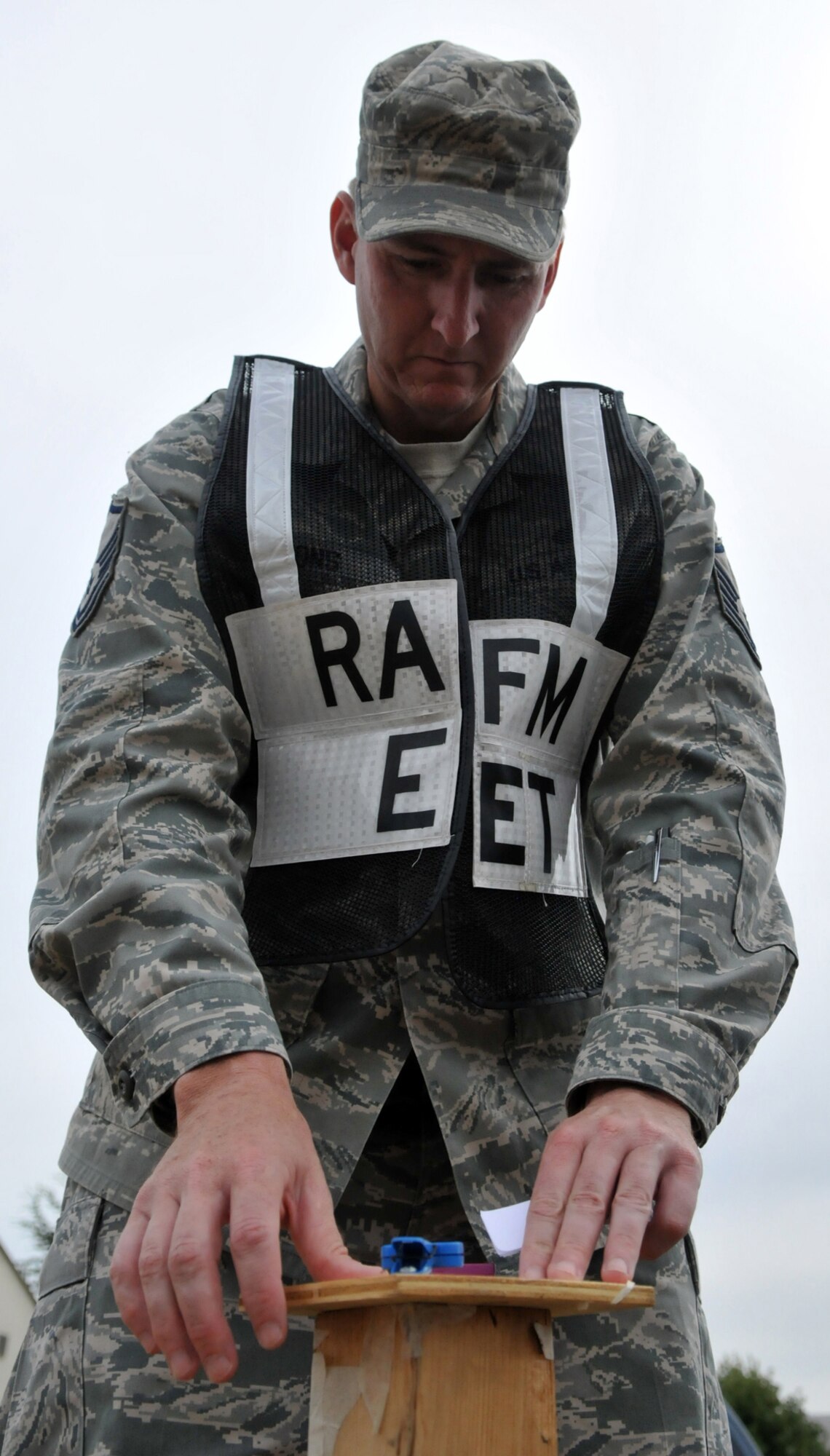 RAF MILDENHALL, England -- Master Sgt. Paul Lyons, 100th Air Refueling Wing Exercise Evaluation Team member, places "contaminated" chemical detection paper on a post during an exercise July 20.  EET members are responsible for conducting scenarios during exercises and evaluating the reactions of those involved.  (U.S. Air Force photo/Staff Sgt. Austin M. May)