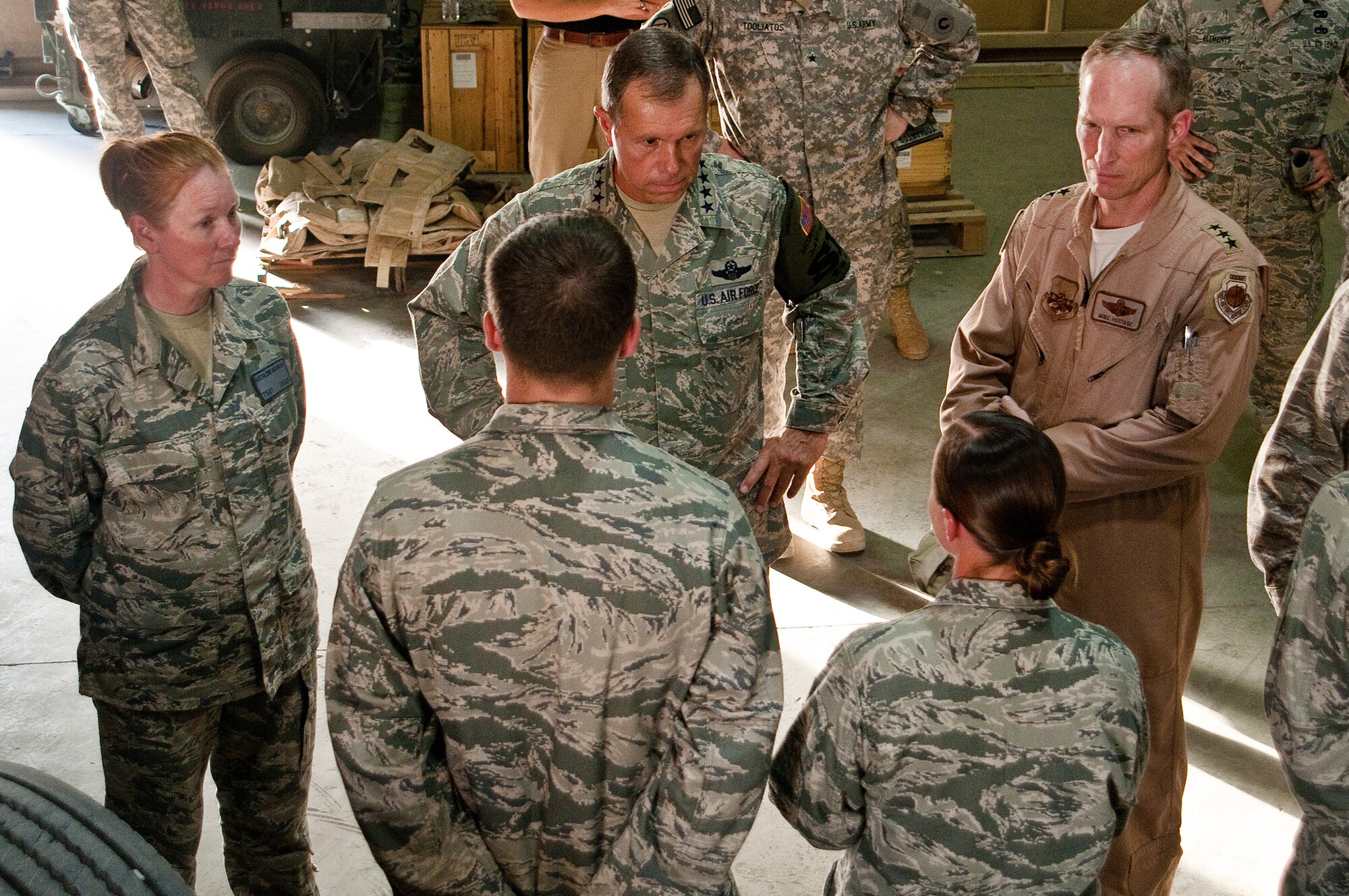 SOUTHWEST ASIA - General William M. Fraser III (second from left), commander of Air Combat Command, listens July 18, 2010, as members of the 387th Expeditionary Logistics Readiness Squadron describe their duties. The only long-haul trucking unit in the U.S. Air Force, the squadron is responsible for transporting supplies and equipment into and out of Iraq from its operational hub at an undisclosed base here. General Fraser was joined on his tour of the unit by Lt. Gen. Mike Hostage (right), commander of U.S. Air Forces Central. (U.S. Air Force photo by Maj. Dale Greer/Released)