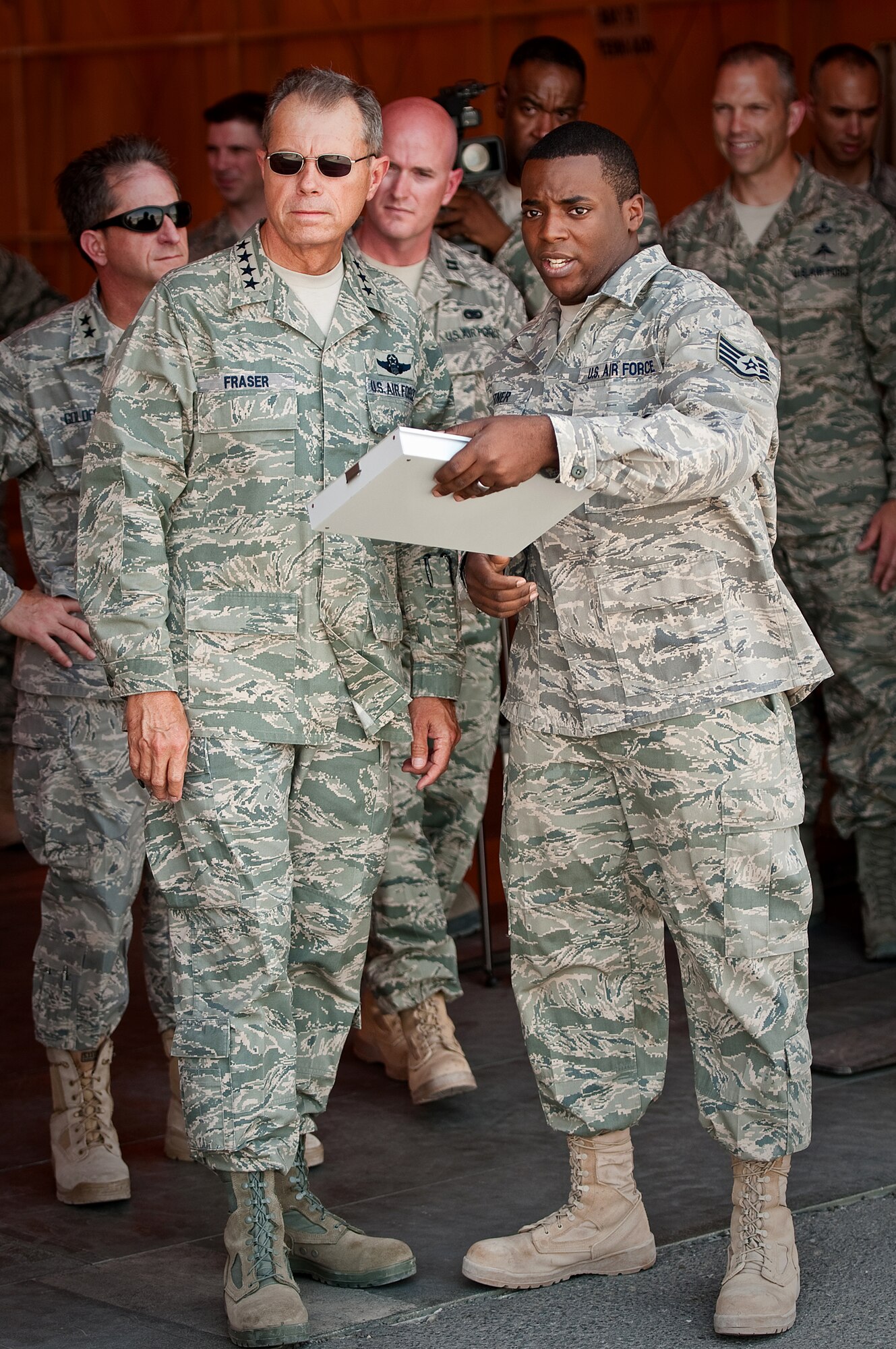 SOUTHWEST ASIA - Staff Sgt. Quincy Whitner of the 386th Aerial Port Flight explains to Gen. William M. Fraser III, commander of Air Combat Command, how pallets of cargo are load-planed for airlift missions during the general's visit to an undisclosed air base here July 18, 2010. General Fraser also toured aircraft maintenance and medical facilities during his visit, which culminated with an Airmen?s Call. (U.S. Air Force photo by Maj. Dale Greer/Released)