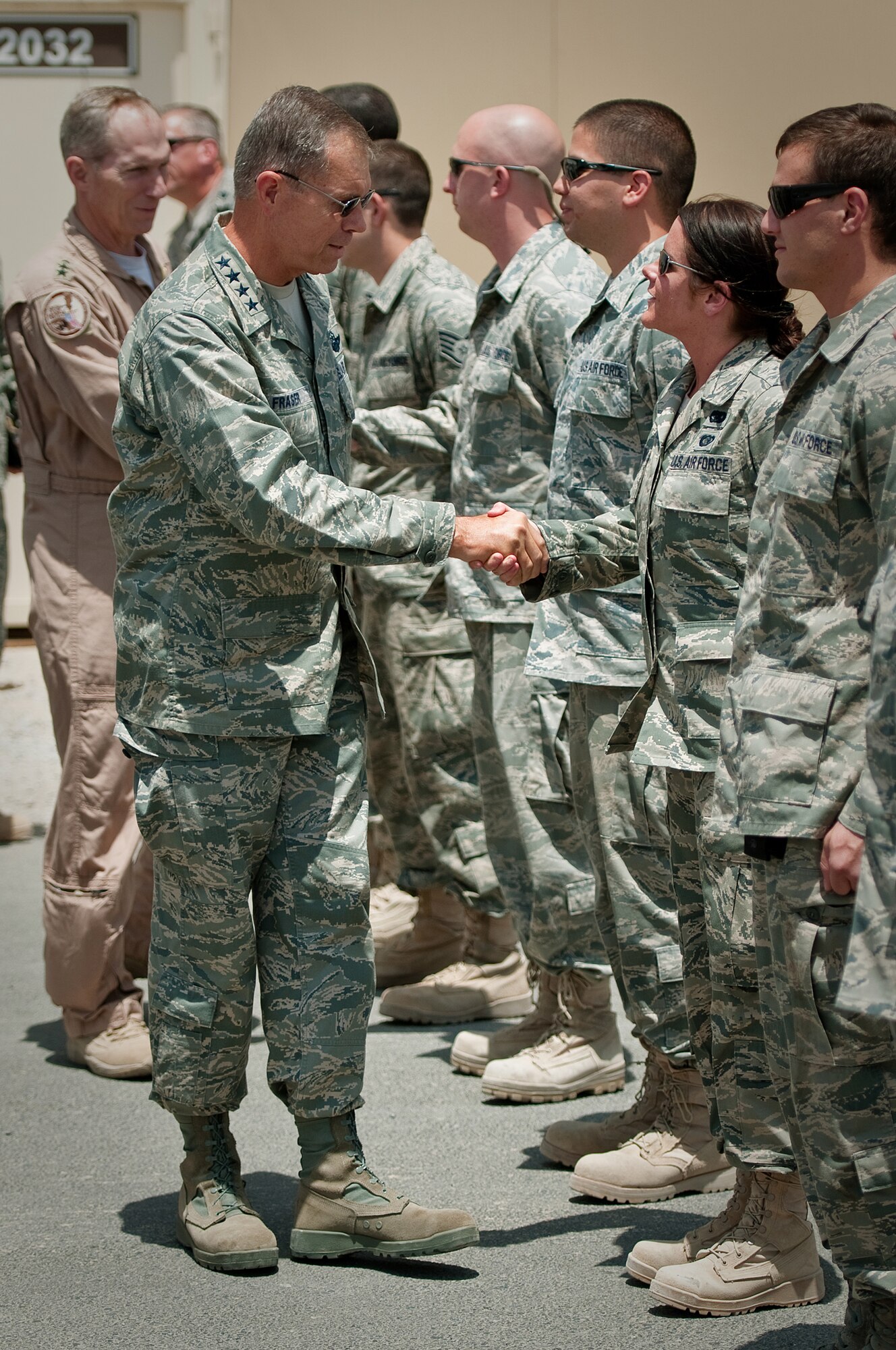 SOUTHWEST ASIA - Gen. William M Fraser III, commander of Air Combat Command, greets members of the 386th Aerial Port Flight following a tour of the flight line at an undisclosed air base here July 18, 2010. General Fraser was given a comprehensive brief on all aspects of the 386th Air Expeditionary Wing during his stay, which included an Airmen's Call for all Air Force troops assigned here. (U.S. Air Force photo by Maj. Dale Greer/Released)