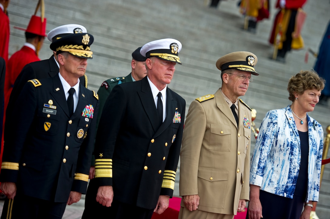 U.S. Army Gen. Walter L. "Skip" Sharp, commander, U.S. Combined Forces Command and U.S. Forces Korea, U.S. Navy Adm. Robert F. Willard, commander, U.S. Pacific Command, U.S. Navy Adm. Mike Mullen, chairman of the Joint Chiefs of Staff, and Kathleen Stephens participate in a memorial ceremony at the War Memorial of Korea in Seoul, South Korea, July 21, 2010.
