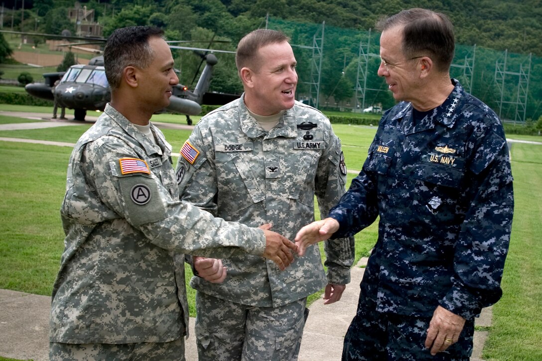 U.S. Army Command Sgt. Maj. Nidal Saeed, left, and Army Col. Hank Dodge, commander of U.S. Army Garrison Red Cloud, South Korea, center, greet U.S. Navy Adm. Mike Mullen, chairman of the Joint Chiefs of Staff, right, as Mullen arrives on the garrison, July 21, 2010. Mullen met with 2nd Infantry Division soldiers assigned to the garrison located between Seoul and the demilitarized zone.