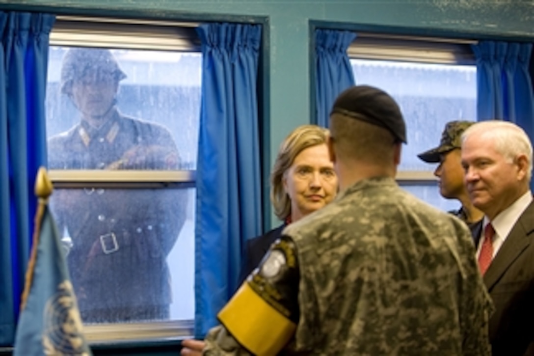 A North Korean soldier looks in through the window of the T2 building as Secretary of State Hillary Clinton and Secretary of Defense Robert M. Gates tour the Demilitarized Zone in Korea on July 21, 2010.  