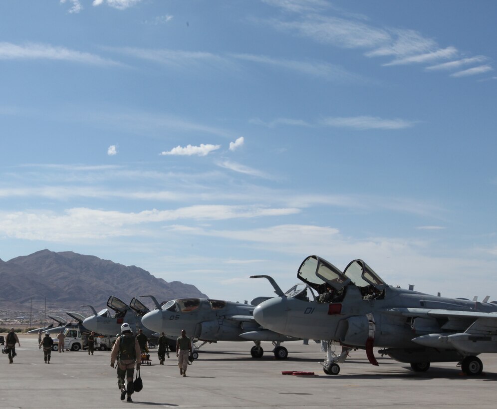 Crewman with Marine Tactical Electronic Warfare Squadron 3 step out to the flight line at Nellis Air Force Base, Nev., to conduct  a preflight walk- through of their EA-6B Prowlers , July 22. VMAQ-3 Marines flew to Las Vegas July 15 from Marine Corps Air Station Cherry Point to participate in a training evolution dubbed Red Flag Class 10-4, which is a two-week advanced aerial combat training exercise hosted at Nellis Air Force Base.