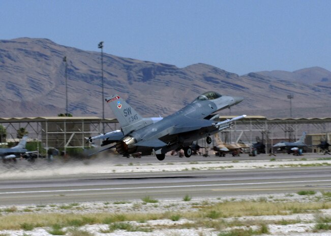 NELLIS AIR FORCE BASE, Nev. -- An F-16 from the 77th Fighter Squadron, Shaw Air Force Base,S.C. takes off from Nellis for a Red Flag 10-4 mission July 21, 2010.  Red Flag is a realistic combat training exercise involving the air forces of the United States and its allies. The exercise is hosted north of Las Vegas on the Nevada Test and Training Range--the U.S. Air Force's premier military training area with more than 12,000 square miles of airspace and 2.9 million acres of land. With 1,900 possible targets, realistic threat systems and an opposing enemy force that cannot be replicated anywhere else in the world, Nellis and the NTTR are the home of a "peacetime battlefield," providing combat air forces with the ability to train to fly, fight and win together.  (U.S. Air Force photo by Airman 1st Class Daniel Phelps).