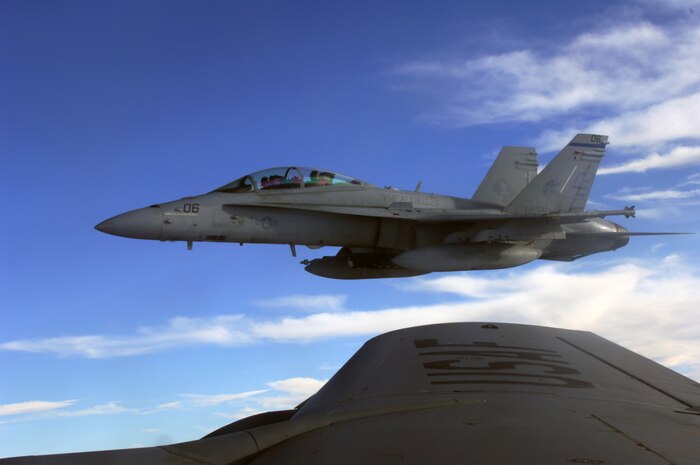NELLIS AIR FORCE BASE, Nev. -- A U.S. Marine Corps F-18 from Marine Attack Squadron 225, Marine Corps Air Station Miramar, Calif., waits to refuel in the skies over the Nevada Test and Training Range during Red Flag-Nellis 10-4 mission July 21, 2010. Red Flag is a realistic combat training exercise involving the air forces of the United States and its allies. The exercise is hosted north of Las Vegas on the Nevada Test and Training Range--the U.S. Air Force's premier military training area with more than 12,000 square miles of airspace and 2.9 million acres of land. With 1,900 possible targets, realistic threat systems and an opposing enemy force that cannot be replicated anywhere else in the world, Nellis and the NTTR are the home of a "peacetime battlefield," providing combat air forces with the ability to train to fly, fight and win together. (U.S. Air Force photo by Airman 1st Class Daniel Phelps)