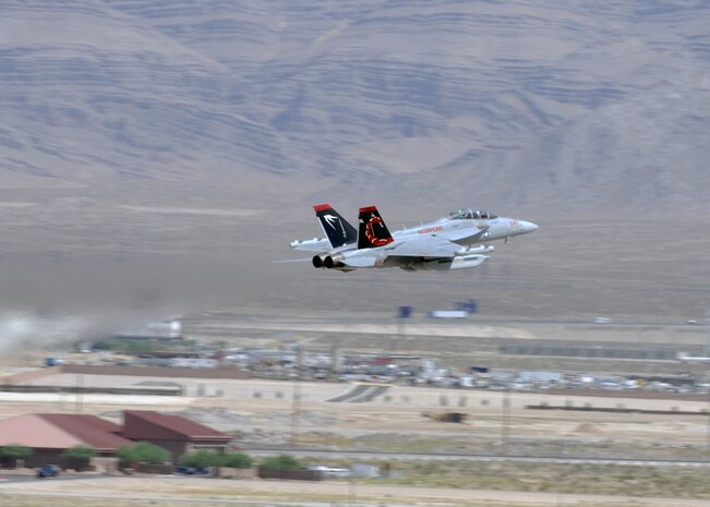 NELLIS AIR FORCE BASE, Nev. -- A U.S. Navy EA-18G from Electronic Attack Squadron  132, Naval Air Station Whidbey Island, Wash. takes off for a Red Flag 10-4 mission July 20, 2010. Red Flag is a realistic combat training exercise involving the air forces of the United States and its allies. The exercise is hosted north of Las Vegas on the Nevada Test and Training Range--the U.S. Air Force's premier military training area with more than 12,000 square miles of airspace and 2.9 million acres of land. With 1,900 possible targets, realistic threat systems and an opposing enemy force that cannot be replicated anywhere else in the world, Nellis and the NTTR are the home of a "peacetime battlefield," providing combat air forces with the ability to train to fly, fight and win together. (U.S. Air Force photo by Airman 1st Class Daniel Phelps)