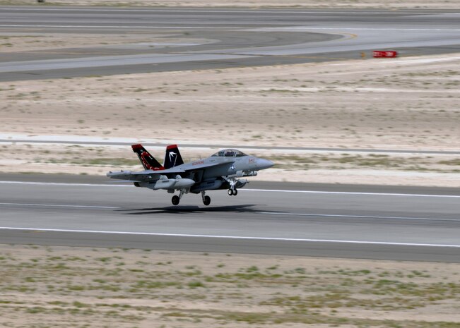 NELLIS AIR FORCE BASE, Nev. -- A U.S. Navy EA-18G from Electronic Attack Squadron  132, Naval Air Station Whidbey Island, Wash. takes off for a Red Flag 10-4 mission July 20, 2010. Red Flag is a realistic combat training exercise involving the air forces of the United States and its allies. The exercise is hosted north of Las Vegas on the Nevada Test and Training Range--the U.S. Air Force's premier military training area with more than 12,000 square miles of airspace and 2.9 million acres of land. With 1,900 possible targets, realistic threat systems and an opposing enemy force that cannot be replicated anywhere else in the world, Nellis and the NTTR are the home of a "peacetime battlefield," providing combat air forces with the ability to train to fly, fight and win together. (U.S. Air Force photo by Airman 1st Class Daniel Phelps)