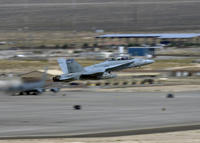 NELLIS AIR FORCE BASE, Nev. -- A U.S. Marine Corps F-18 from Marine Fighter Attack Squadron 225, Marine Corps Air Station Miramar, Calif. takes off from the runway during Red Flag 10-4 July 20, 2010. Red Flag is a realistic combat training exercise involving the air forces of the United States and its allies. The exercise is hosted north of Las Vegas on the Nevada Test and Training Range--the U.S. Air Force's premier military training area with more than 12,000 square miles of airspace and 2.9 million acres of land. With 1,900 possible targets, realistic threat systems and an opposing enemy force that cannot be replicated anywhere else in the world, Nellis and the NTTR are the home of a "peacetime battlefield," providing combat air forces with the ability to train to fly, fight and win together.