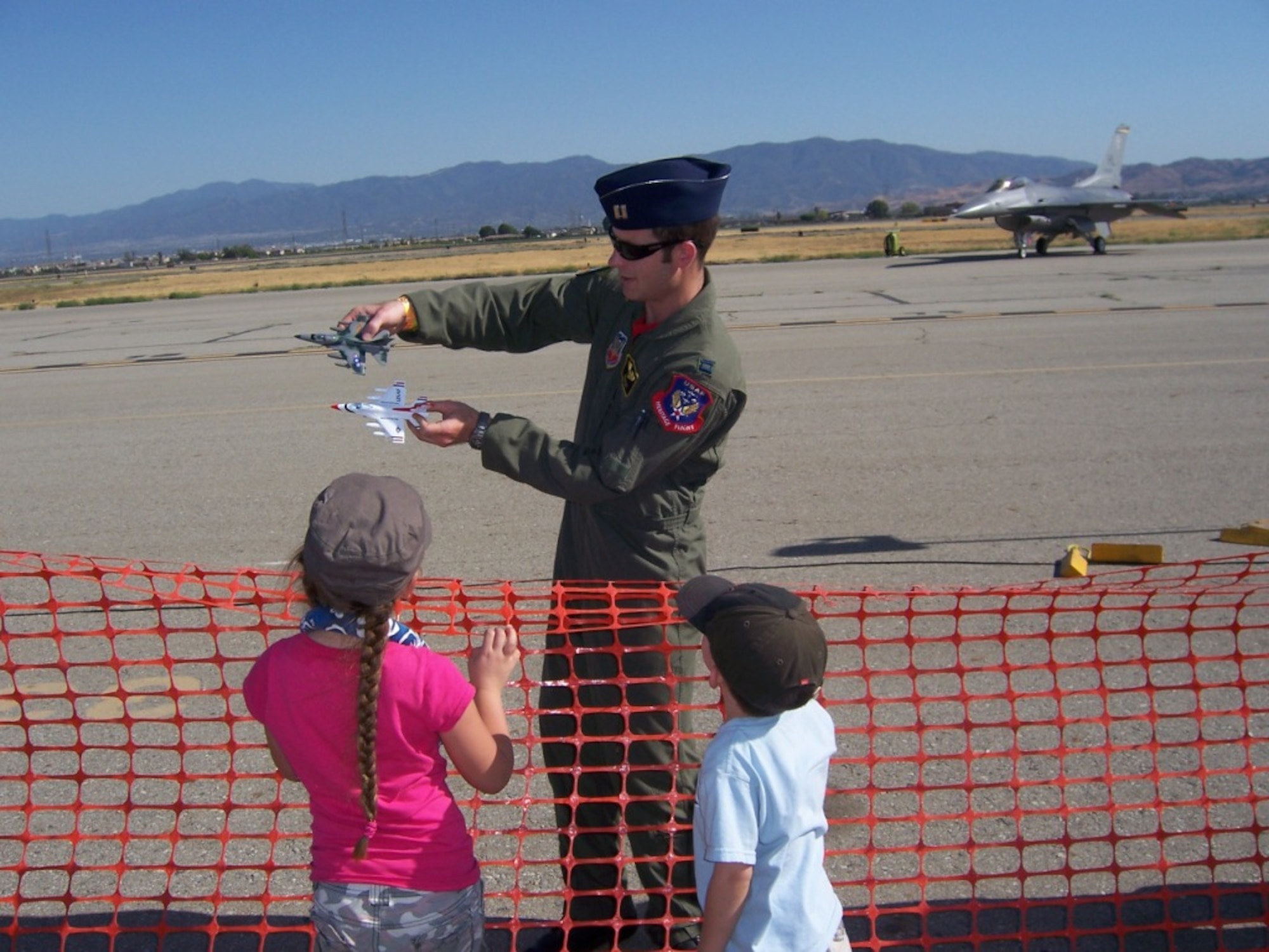 KUNSAN AIR BASE, Republic of Korea – Capt. Ryan Riley, here a safety observer for the F-16 Viper West demonstration team, shows family members how the team flies in formation during the 2008 Chino Airshow in California. Captain Riley, now a 35th Fighter Squadron instructor pilot, was recently selected to join the Air Force Thunderbirds team as Thunderbird No. 2, the left wing for the squadron. (U.S. Air Force photo/Courtesy photo)