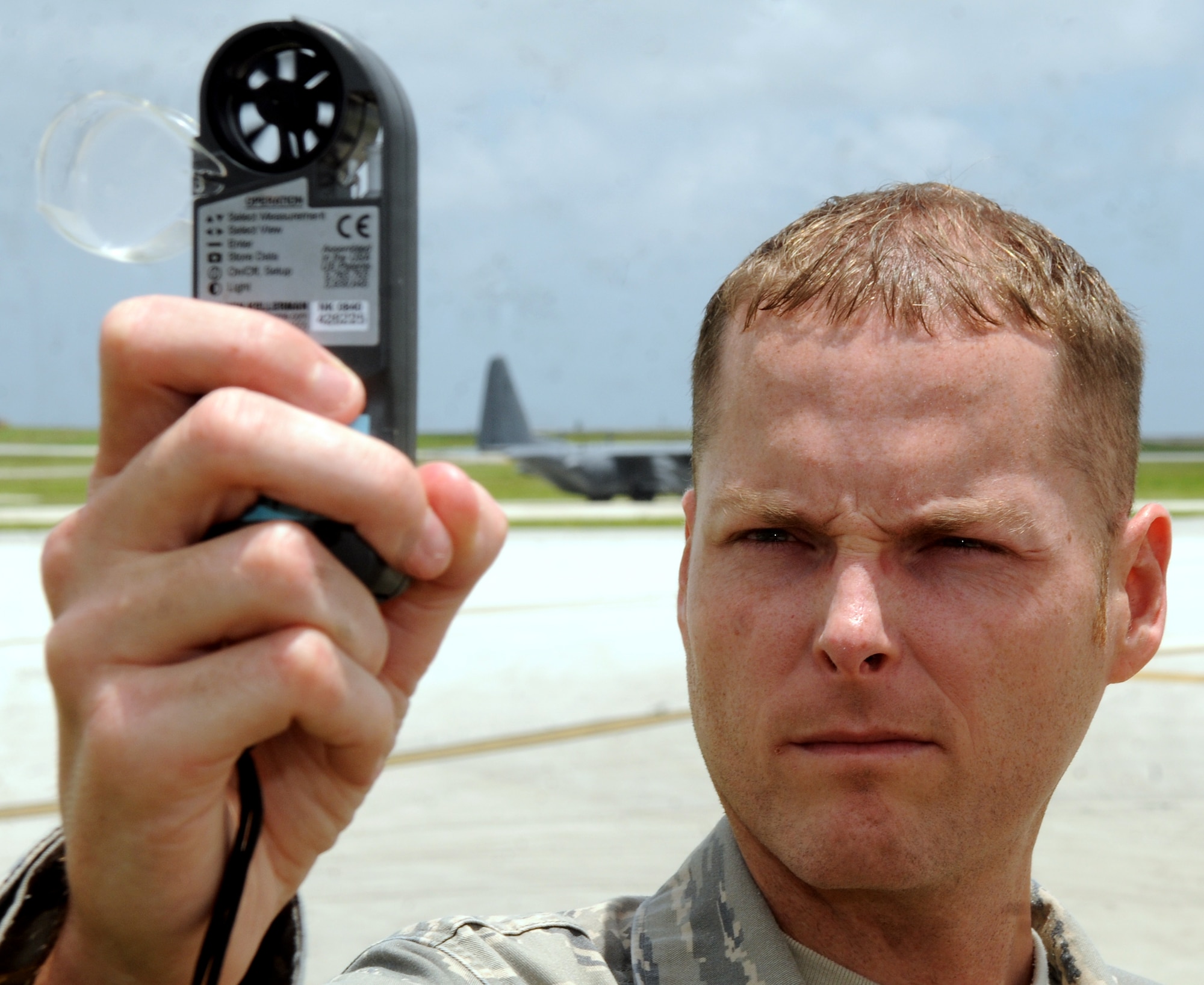 ANDERSEN AIR FORCE BASE, Guam - Staff Sgt. William Robinson, 36th Operations Support Squadron weather forecaster, checks wind speed, temperature and other weather conditions July 7. The 36th OSS weather flight provides weather products and knowledge to expeditionary flying squadrons, wing staff, transient aircrews and flight line operations. They ensure the local populace has the information they need to react to any weather conditions. (U.S. Air Force photo/ Airman 1st Class Anthony Jennings)