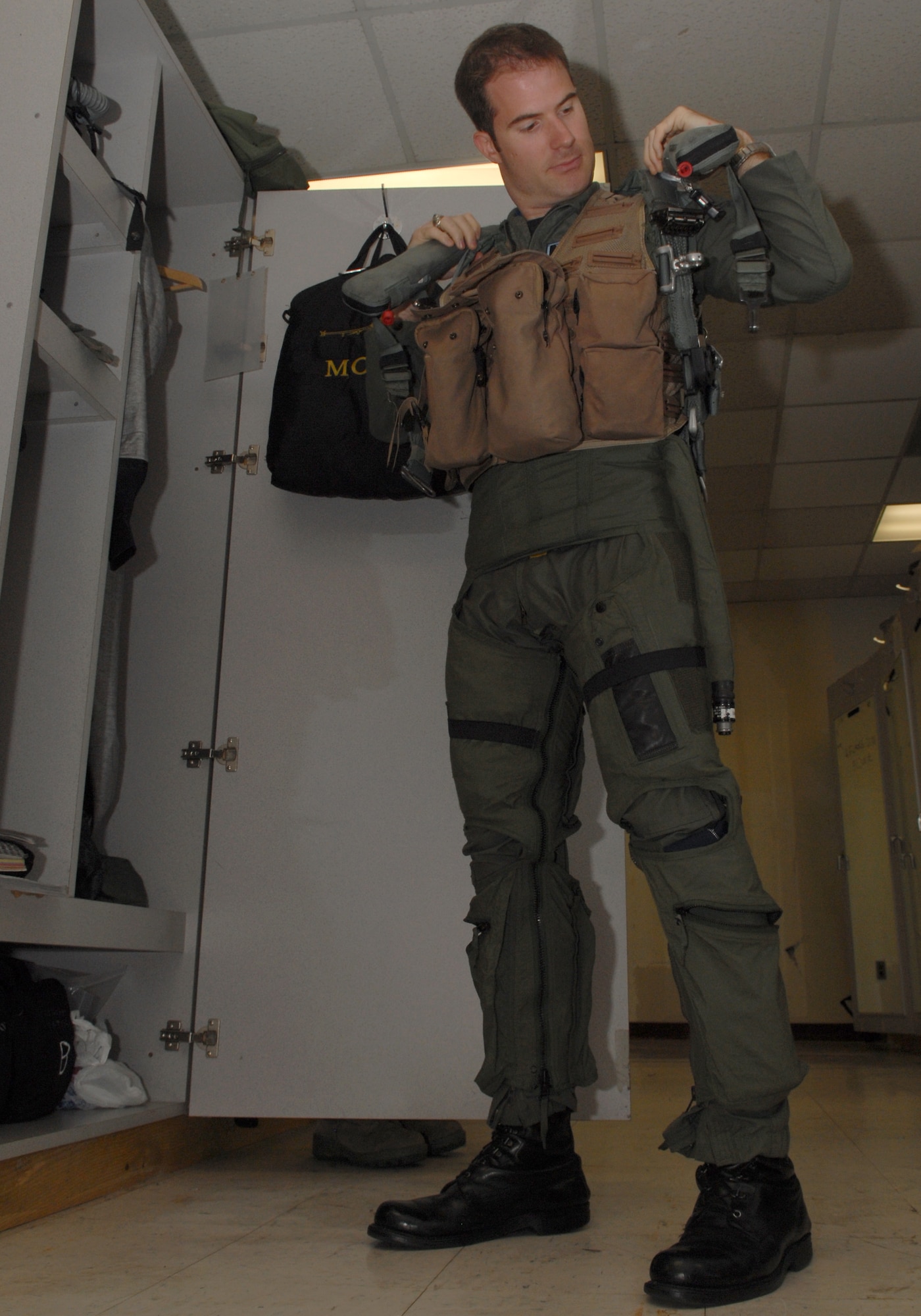 KUNSAN AIR BASE, Republic of Korea – Capt. Ryan Riley, 35th Fighter Squadron instructor pilot, dons his life support gear before stepping to a flight. Captain Riley was recently selected to join the Air Force Thunderbirds team as Thunderbird No. 2, the left wing for the squadron. (U.S. Air Force photo/Senior Airman Roy Lynch)