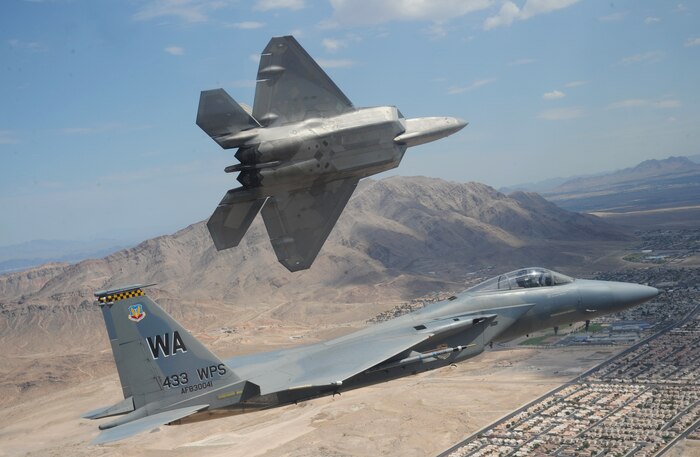 NELLIS AIR FORCE BASE, Nev.--An F-22A Raptor pitches out for landing while flying with an F-15C Eagle over Nellis Air Force Base July 16, 2010. Both aircraft are from the 433rd WPS--the only Weapons School squadron that operates two different types of aircraft.  The Weapons School began in the late 1940s as the U.S. Air Force Gunnery School and teaches graduate-level instructor courses, providing the world's most advanced training in weapons and tactics employment. (U.S. Air Force photo by Master Sgt. Kevin J. Gruenwald)


