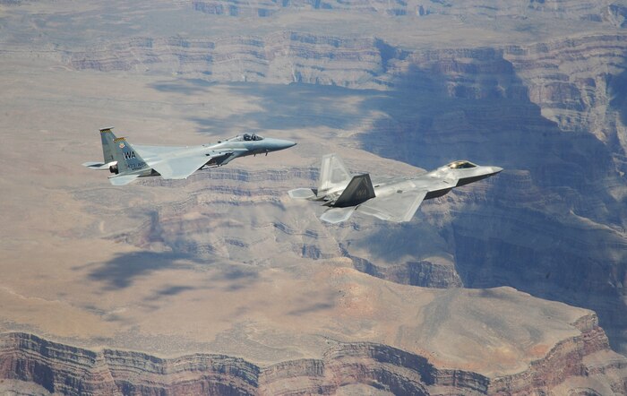 NELLIS AIR FORCE BASE, Nev.--An F-22A Raptor and F-15C Eagle from the U.S. Air Force Weapons School's 433rd Weapons Squadron fly in formation over the Grand Canyon July 16, 2010.  The 433rd WPS is the only Weapons School squadron that operates two different types of aircraft.  The Weapons School began in the late 1940s as the U.S. Air Force Gunnery School and teaches graduate-level instructor courses, providing the world's most advanced training in weapons and tactics employment. (U.S. Air Force photo by Master Sgt. Kevin J. Gruenwald)
